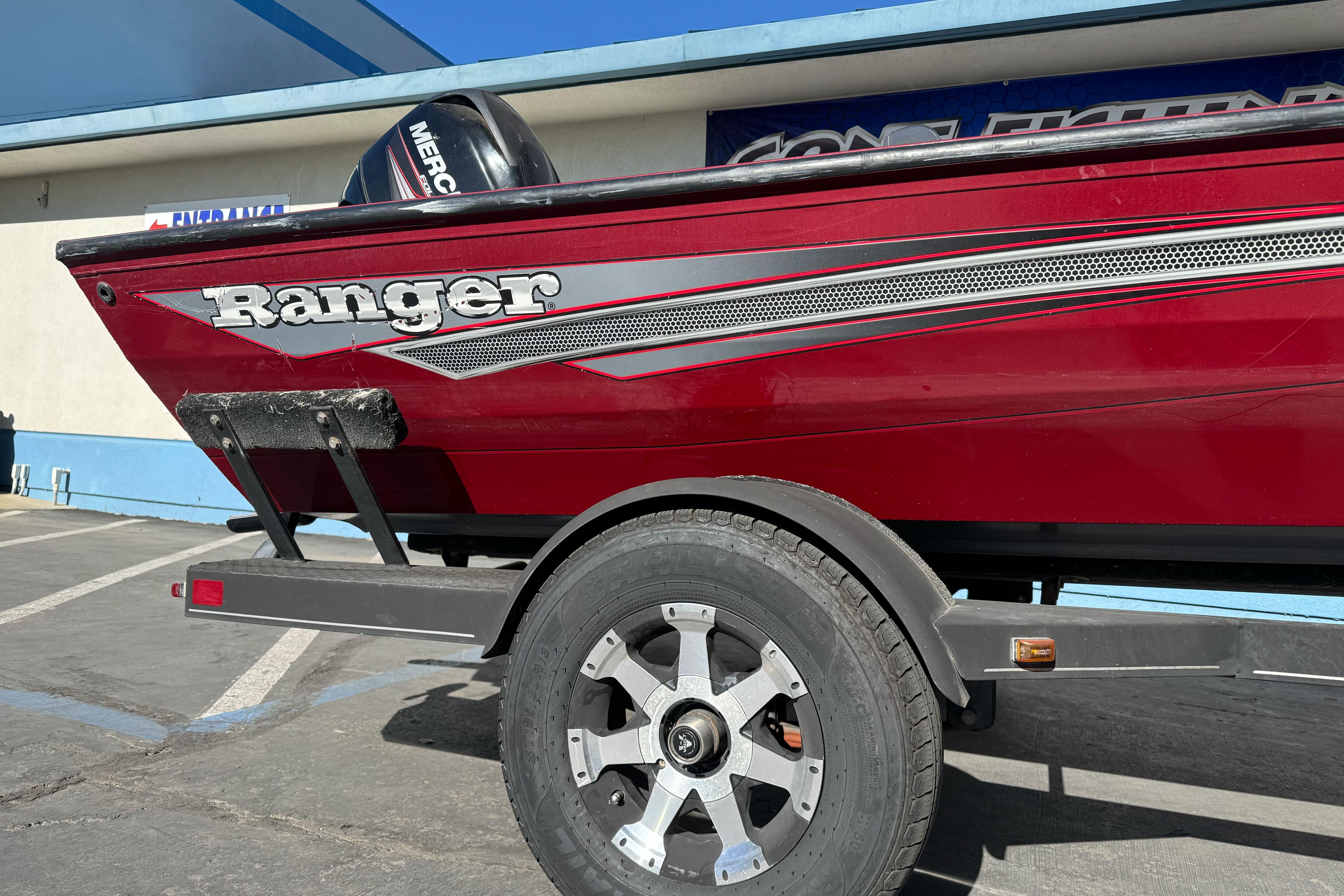 2016 Ranger RT178 boat on trailer, red exterior, parked outdoors.