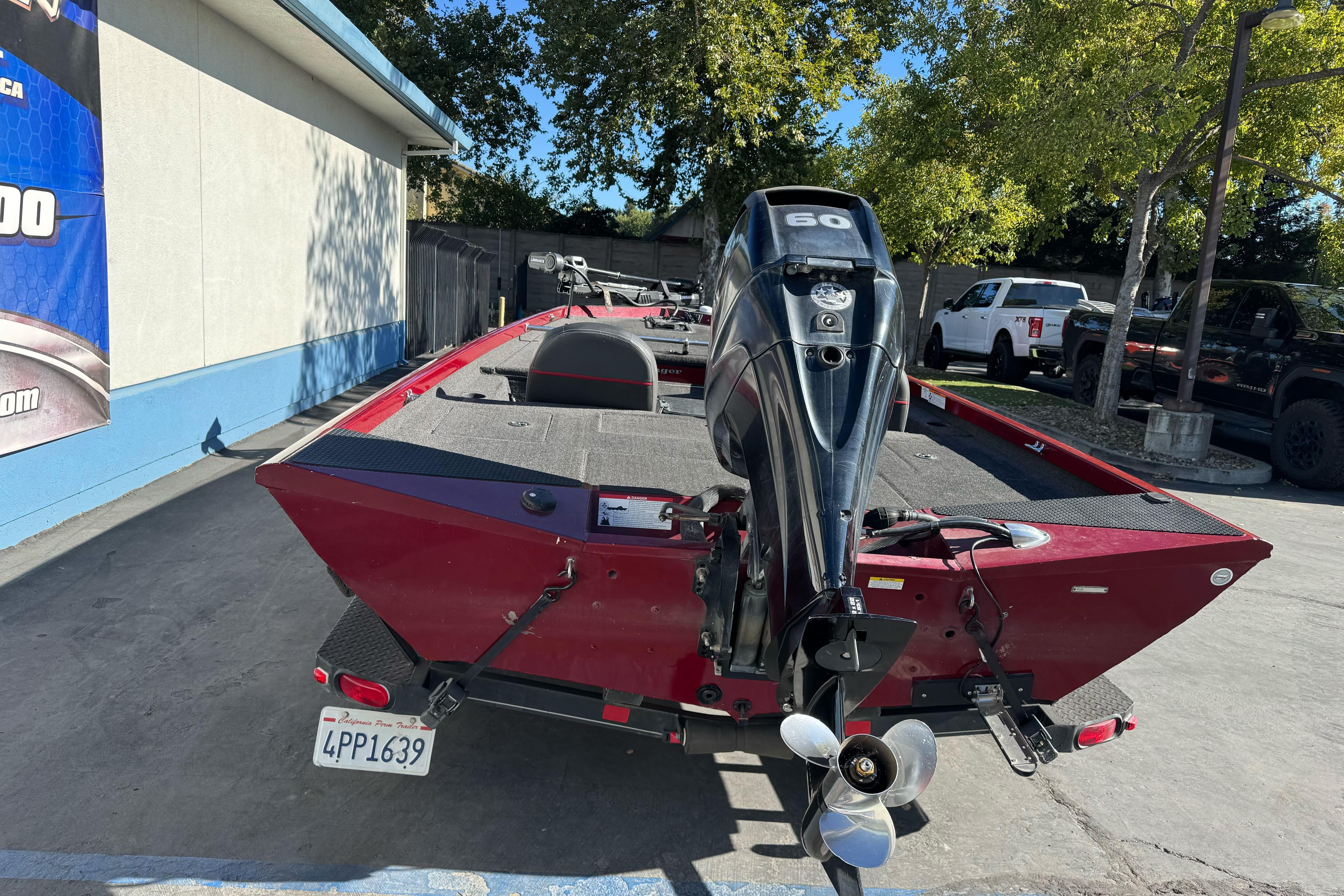 2016 Ranger RT178 boat with outboard motor, parked outdoors on a sunny day.