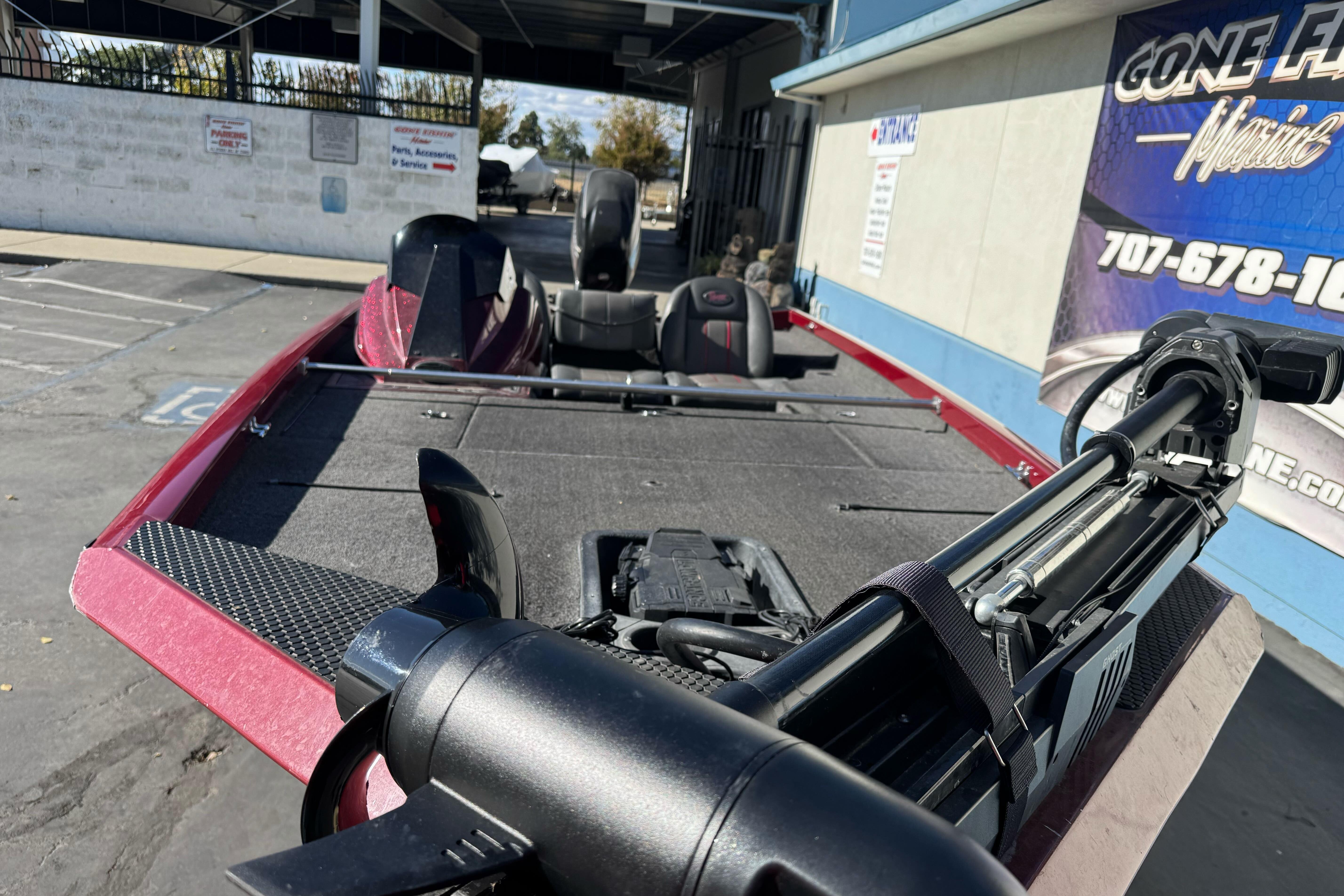 2016 Ranger RT178 boat with trolling motor, parked outdoors near a marine service center.