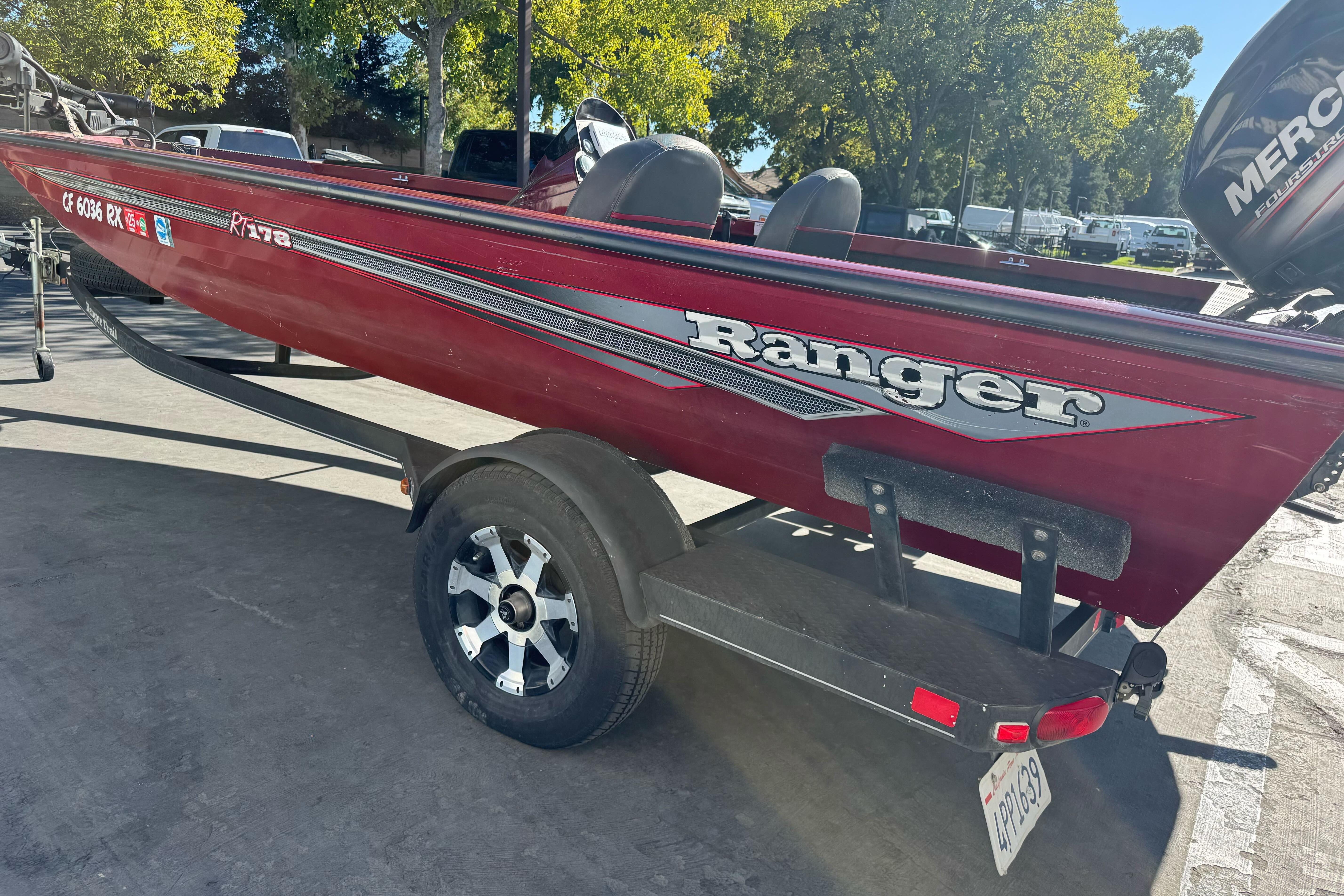 2016 Ranger RT178 boat on trailer, red color, parked outdoors.