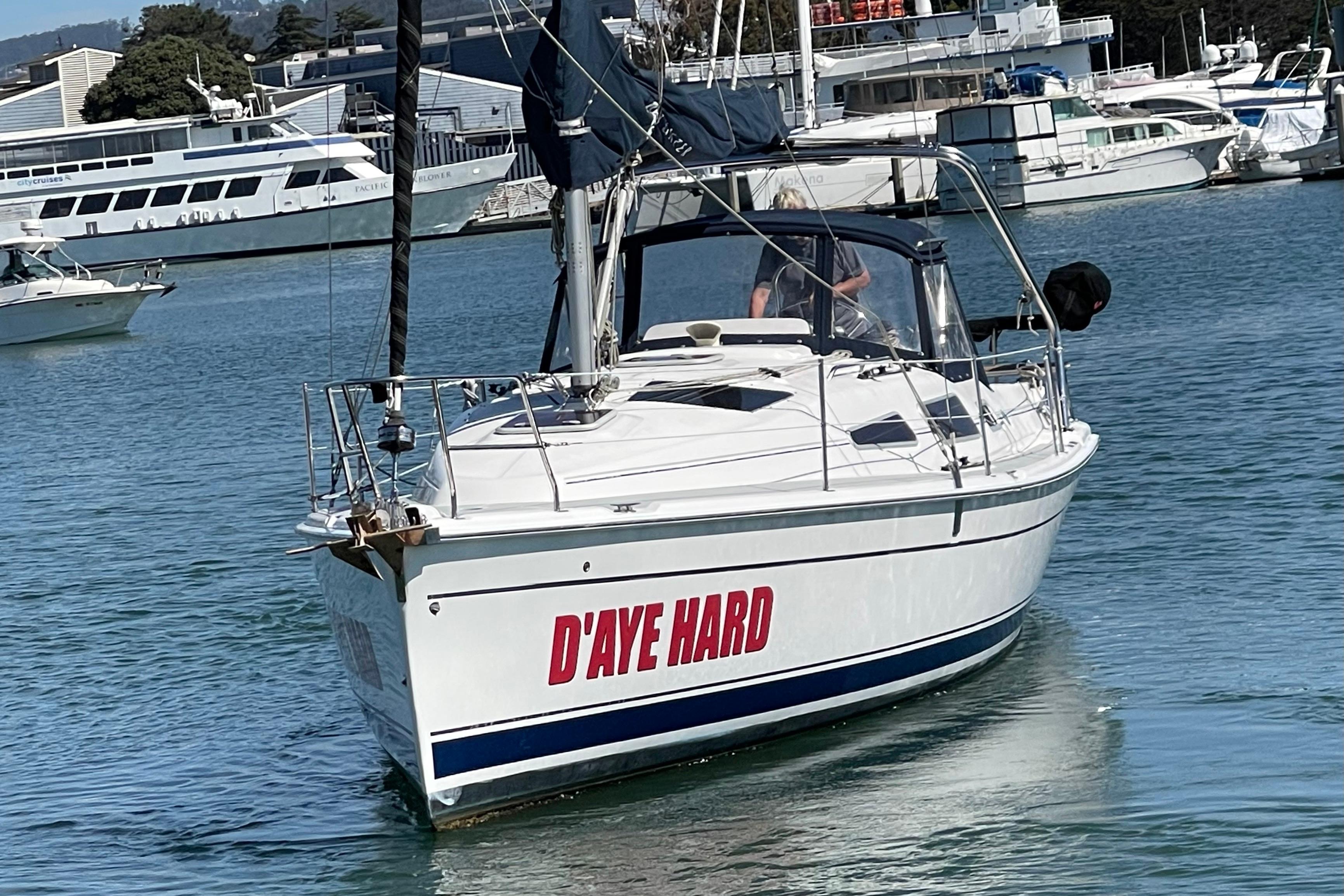 2004 Hunter 33-2 sailboat named "D'AYE HARD" in a marina setting.