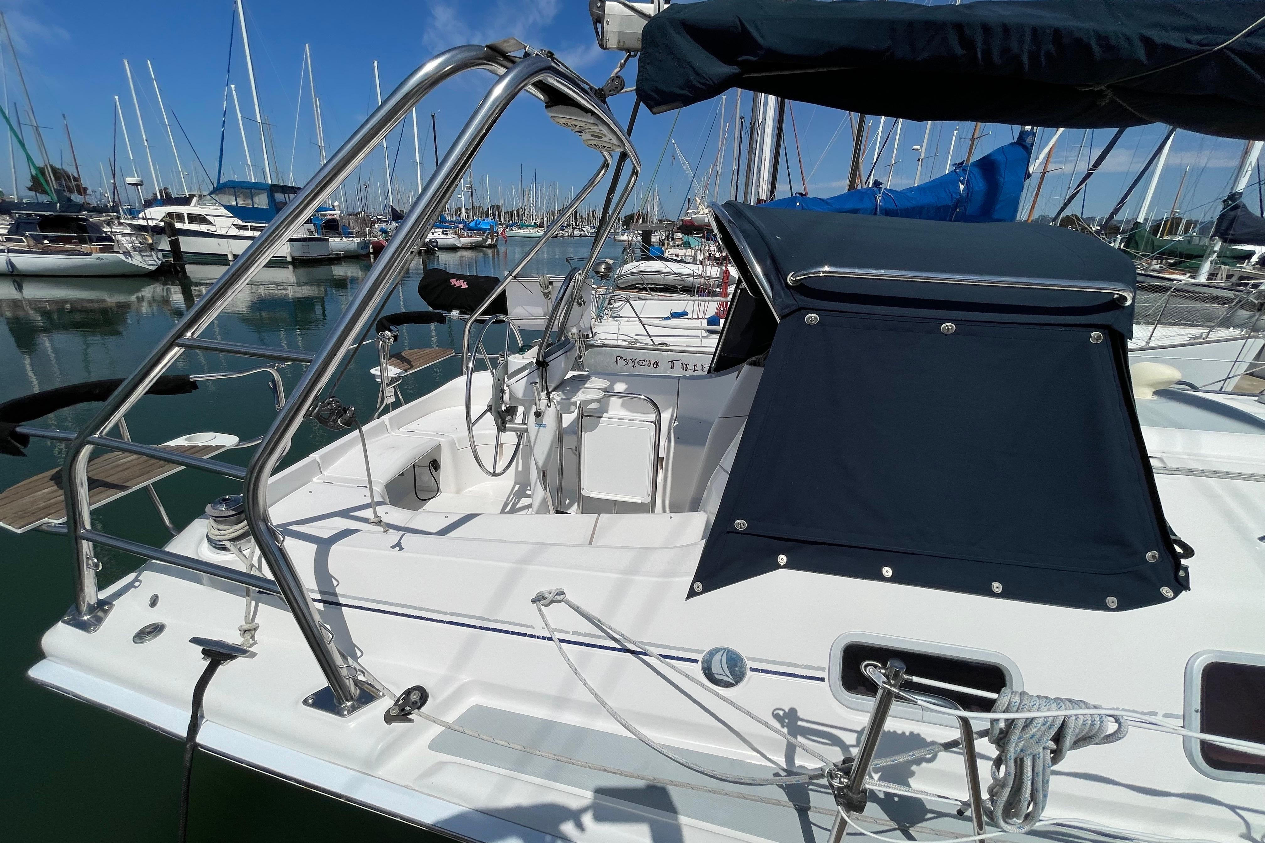 Sailboat Hunter 33-2, 2004 model, docked in marina with stainless steel railings.