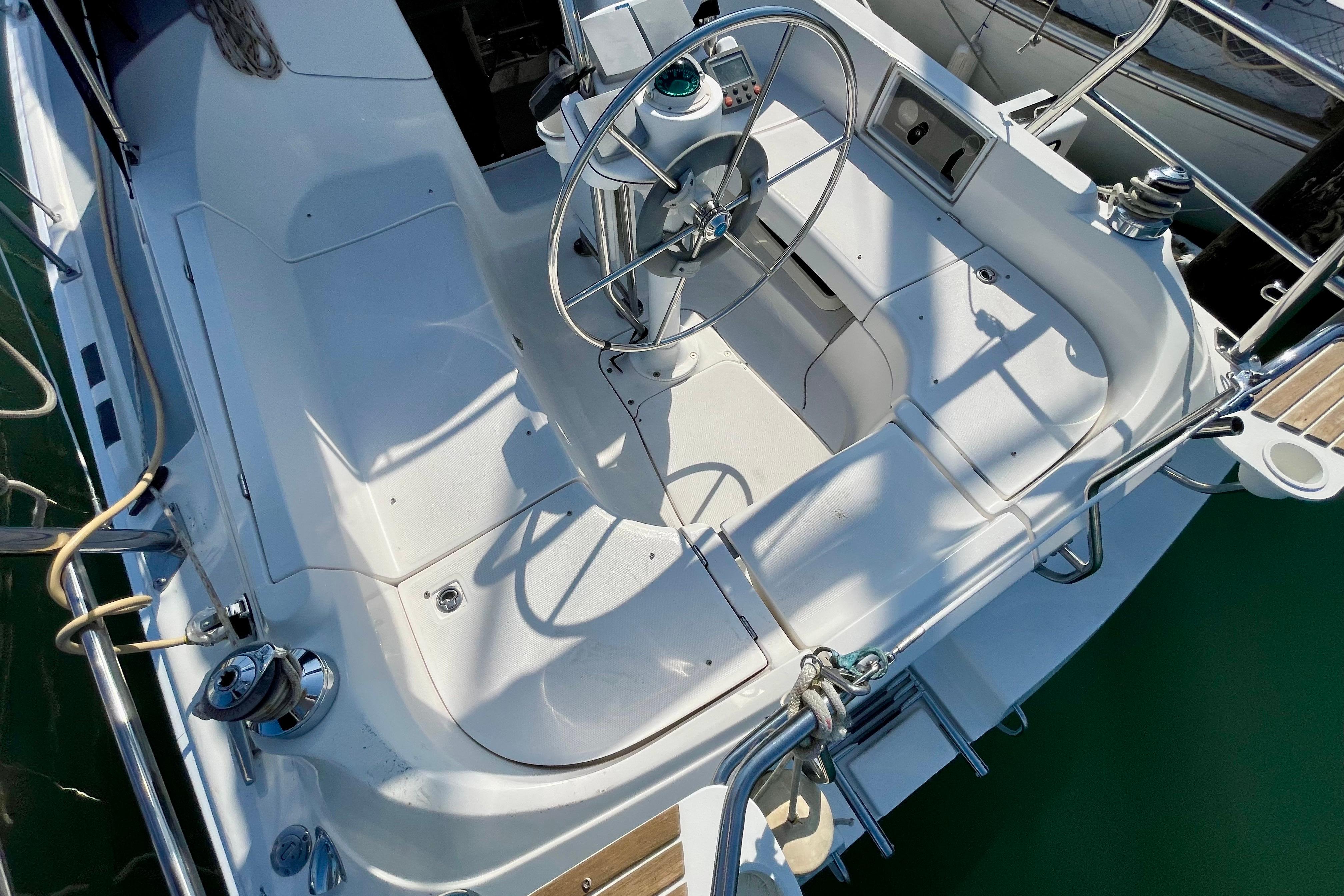 Cockpit of a 2004 Hunter 33-2 sailboat with steering wheel and seating.