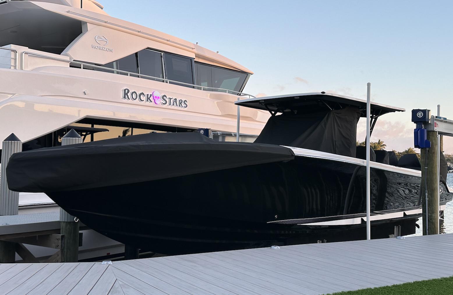 Nor-Tech-390 Sport Center Console 2023 -KY-US-2023 Nor-Tech 390 Sport Center Console boat docked beside a luxury yacht.-9746423 | Thumbnail