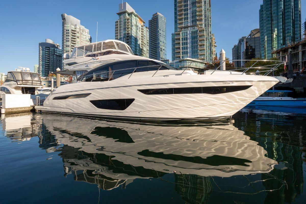 Luxury 2018 Princess S60 yacht docked in urban marina with city skyline backdrop.