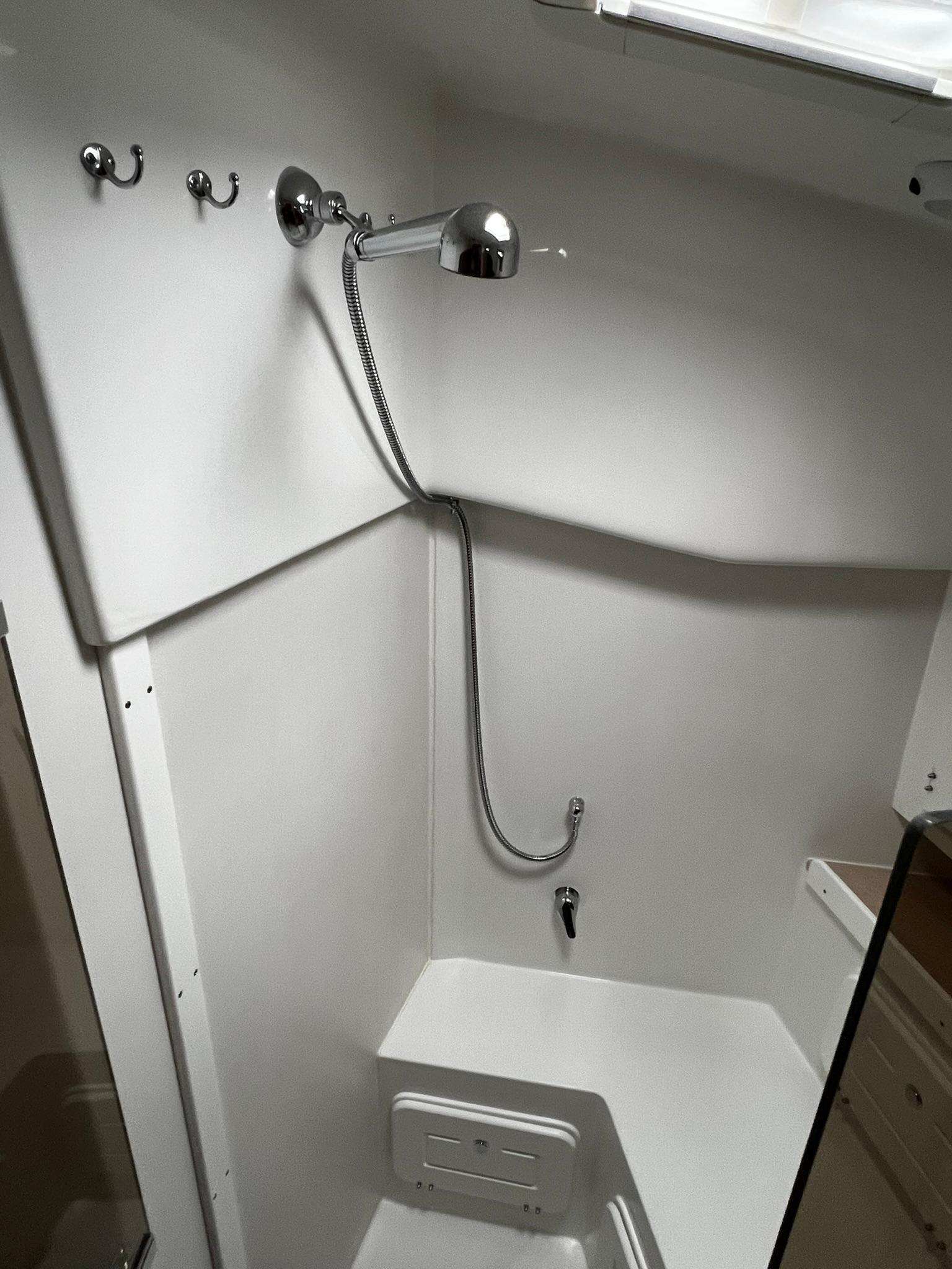 Tartan-395 2025-395 RI-US-Compact shower area in a 2025 Tartan 395 yacht, featuring modern fixtures and white interior.-9826454 | Thumbnail