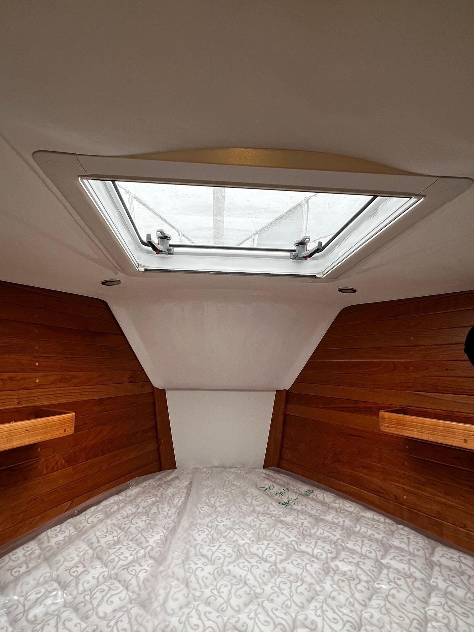 Tartan-395 2025-395 RI-US-Interior cabin of 2025 Tartan 395 yacht with wooden paneling and skylight.-9826454 | Thumbnail