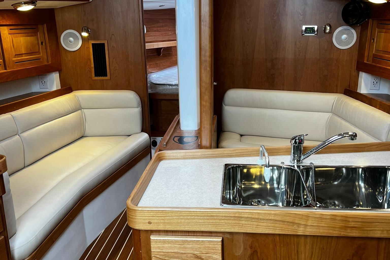 Tartan-395 2025-395 RI-US-Interior of 2025 Tartan 395 yacht with modern seating and kitchen area.-9826454 | Thumbnail