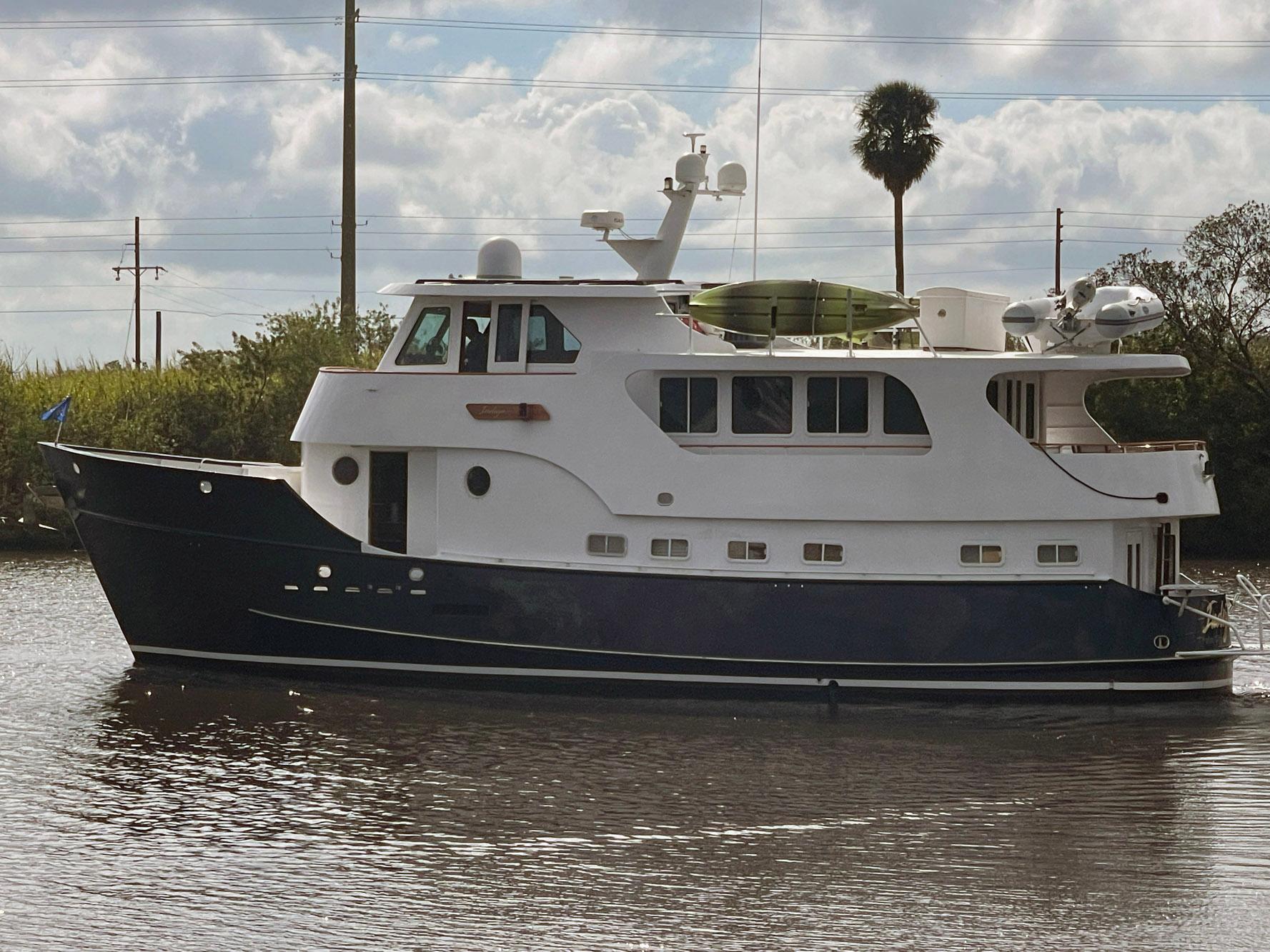 1997 Real Ships 61 Islander yacht on calm water under cloudy sky.