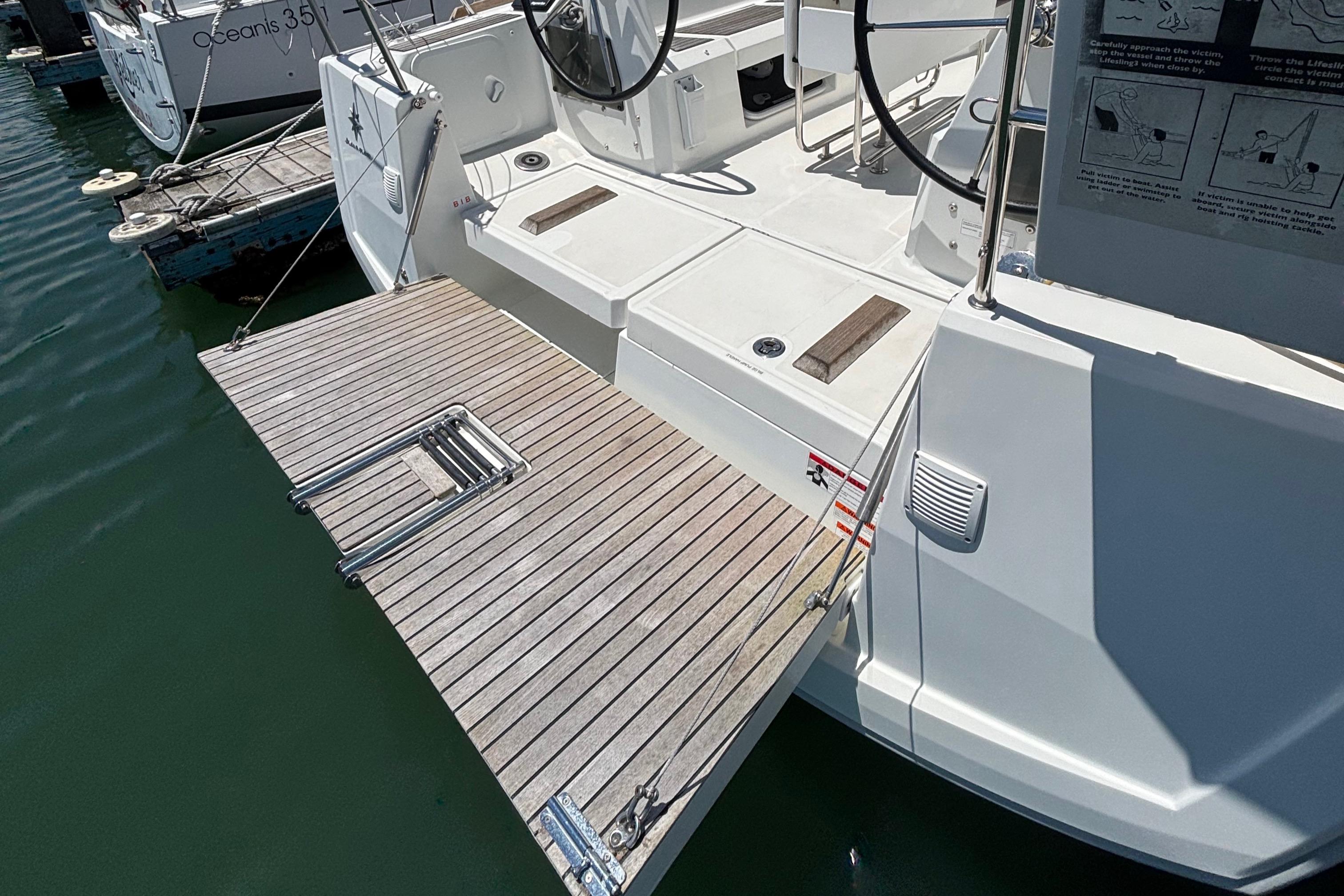 Jeanneau Sun Odyssey 349, 2021 model, featuring a wooden swim platform and ladder.