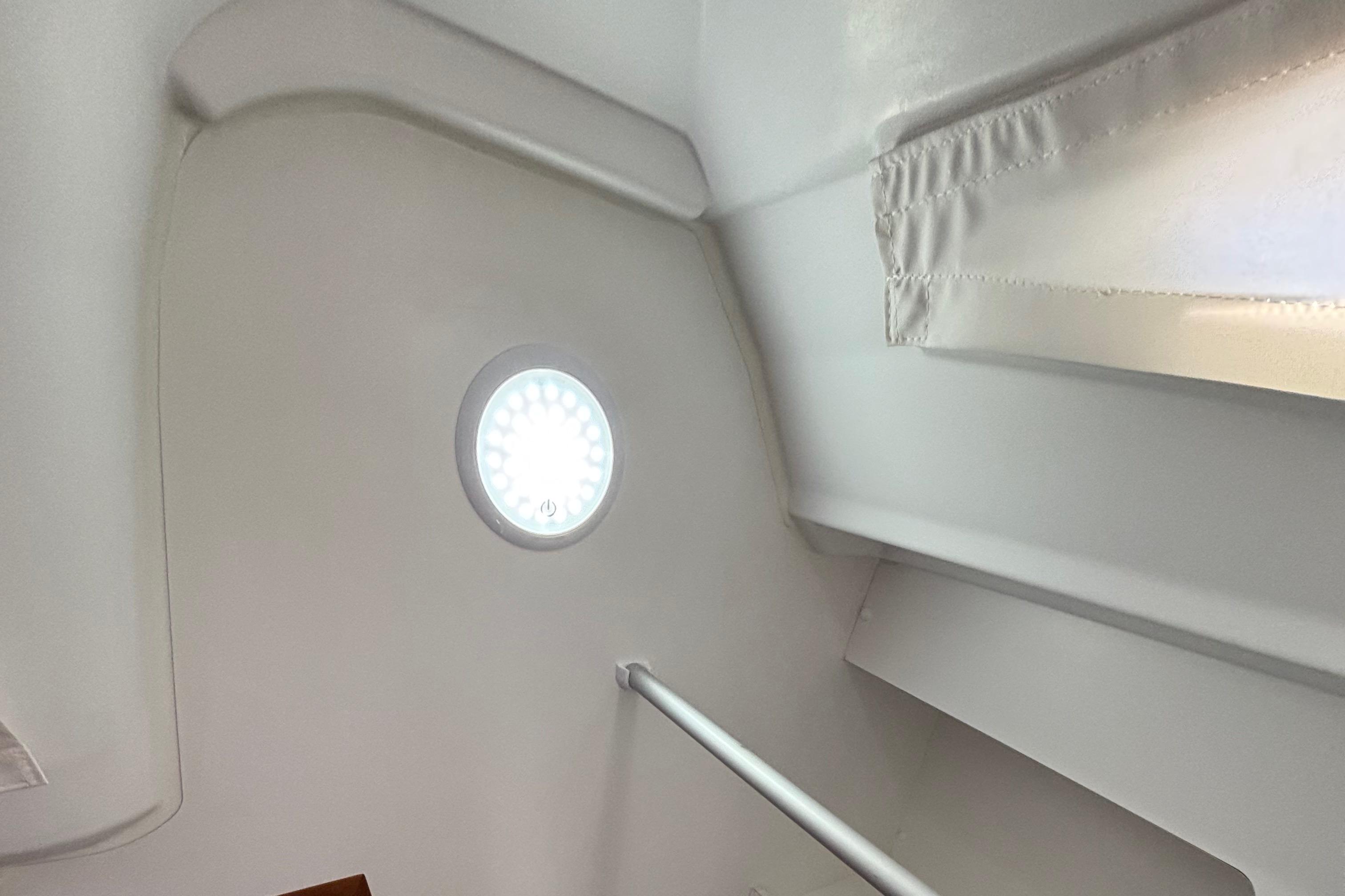 Interior of 2021 Jeanneau Sun Odyssey 349 yacht with round light fixture.