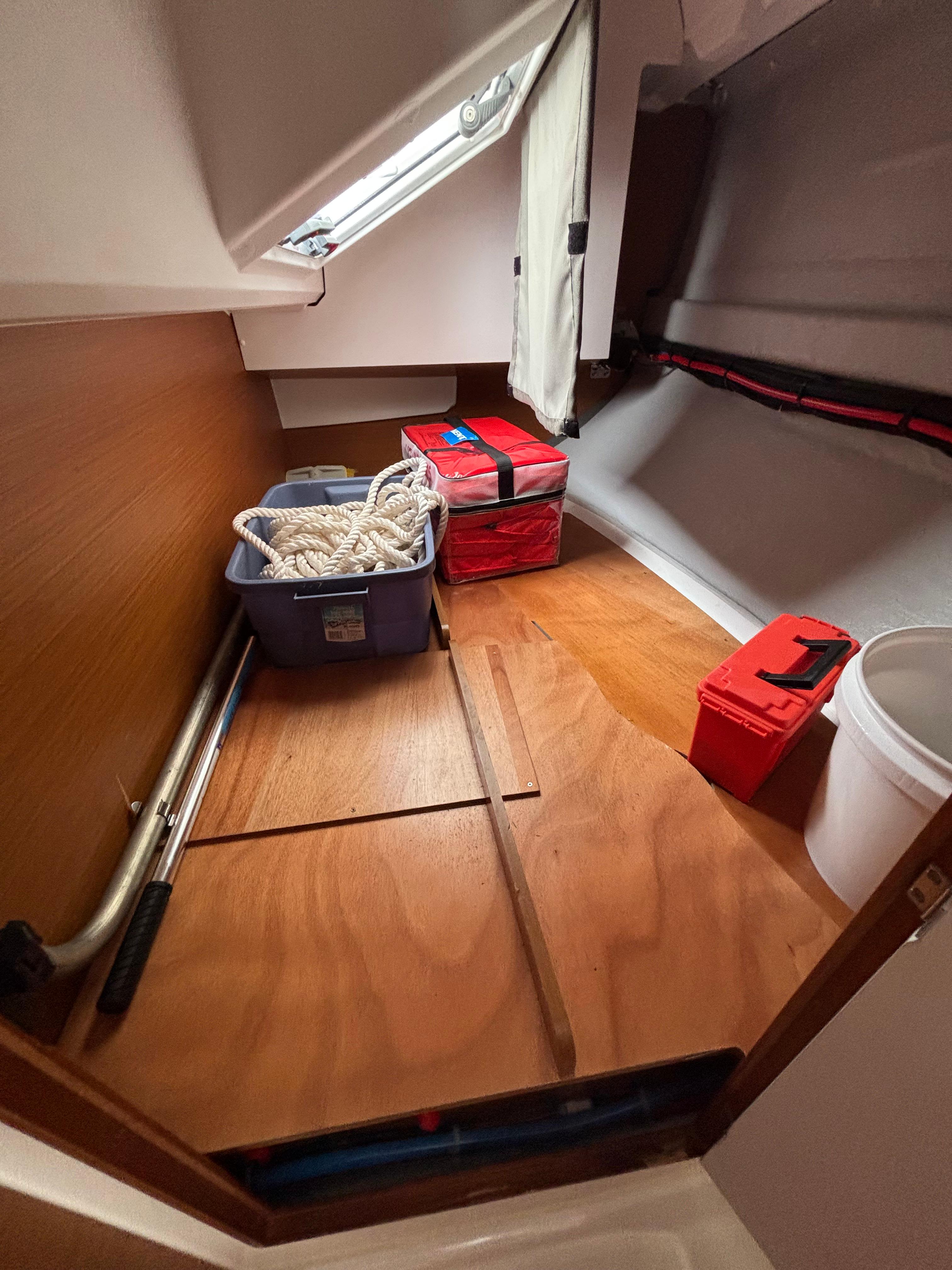 Storage area in a 2021 Jeanneau Sun Odyssey 349 sailboat with ropes and equipment.