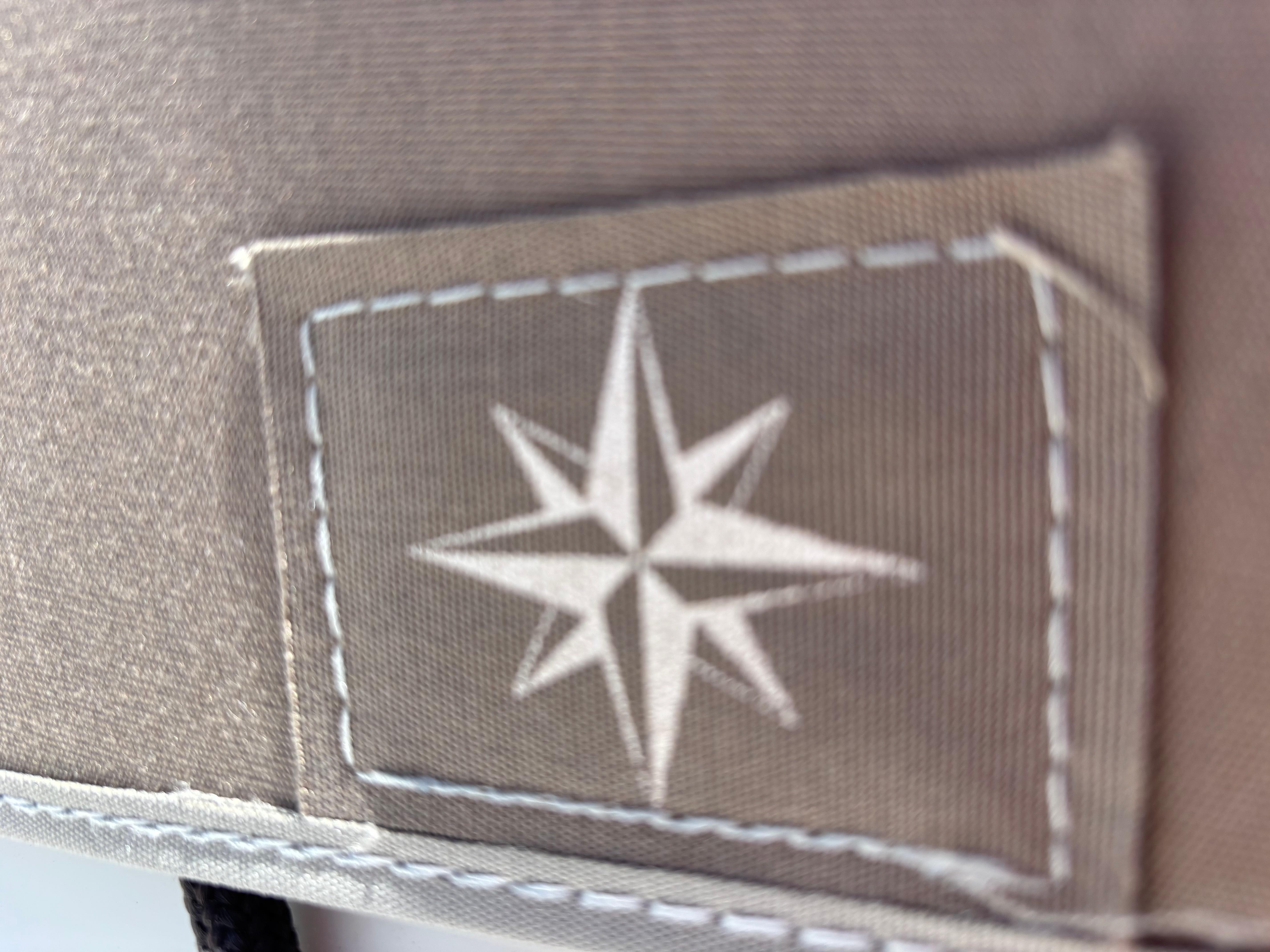 Close-up of a stitched compass rose emblem on Jeanneau Sun Odyssey 349, 2021 model.