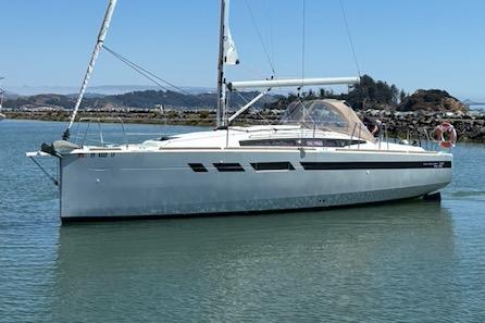 2021 Jeanneau Sun Odyssey 349 sailboat on calm water, clear sky background.