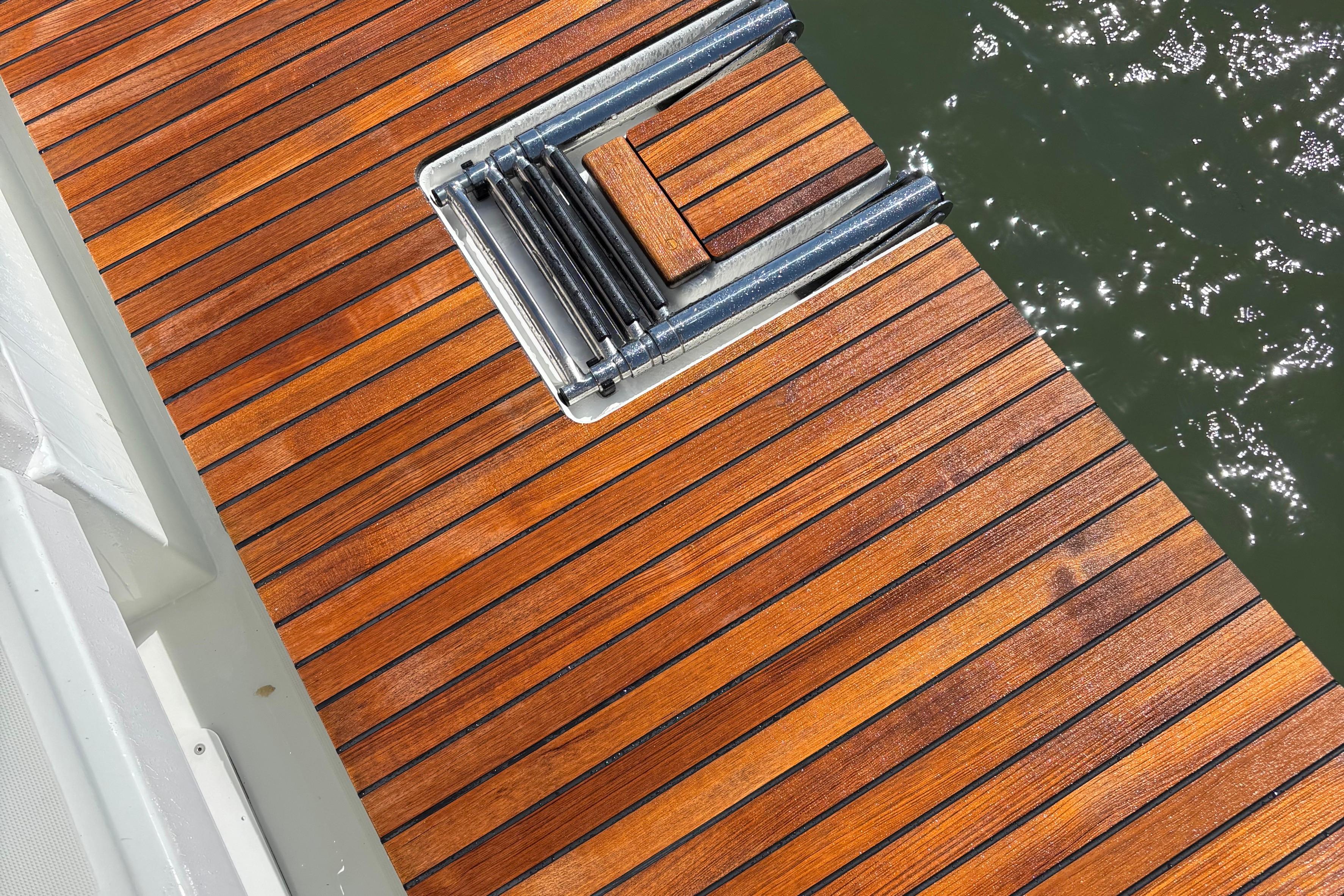 Teak deck of 2021 Jeanneau Sun Odyssey 349 yacht with folding ladder.