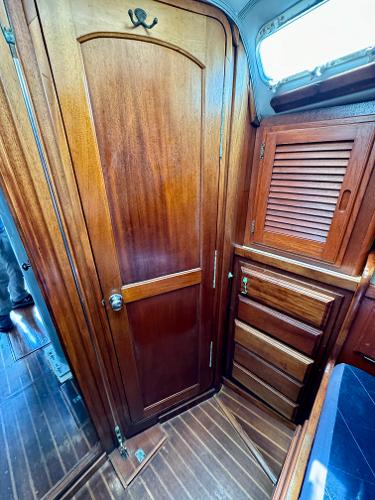 Interior of 1979 Islander IP Peterson 40 sailboat with wooden cabinetry and flooring.