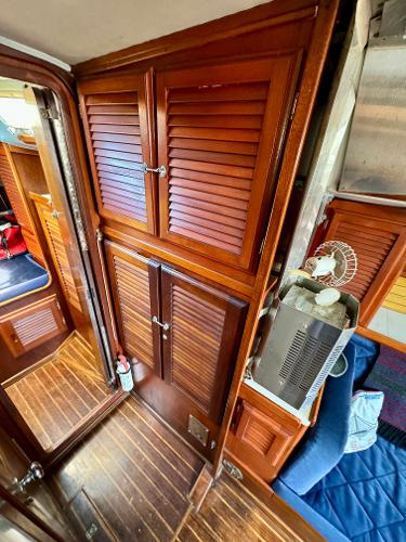 1979 Islander IP Peterson 40 interior with wooden cabinets and seating area.