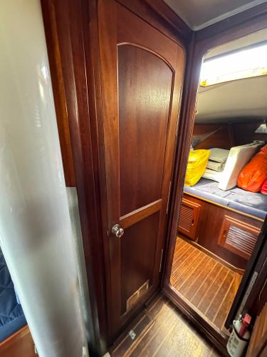 Interior of 1979 Islander IP Peterson 40 sailboat with wooden door and cozy cabin.