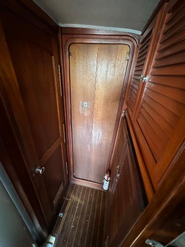 1979 Islander IP Peterson 40 interior with wooden doors and flooring.