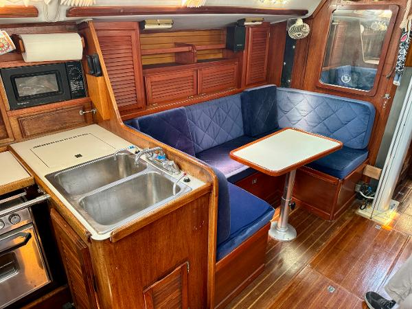 Interior of 1979 Islander IP Peterson 40 sailboat with kitchen and dining area.