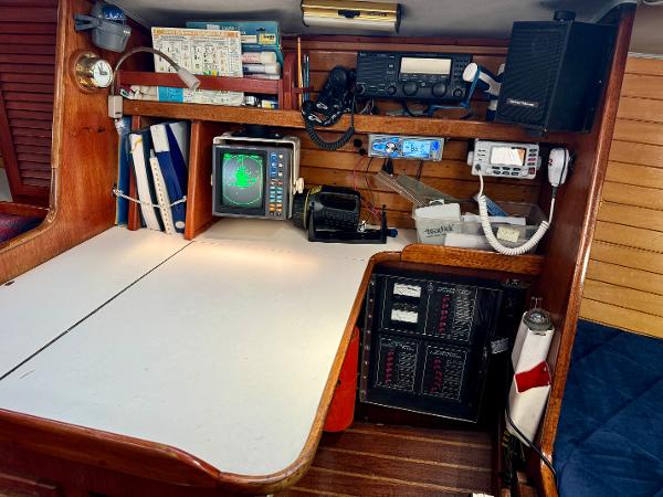 Navigation station on 1979 Islander IP Peterson 40 sailboat with radar and communication equipment.