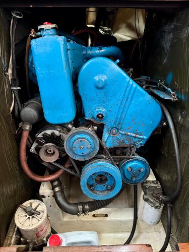 1979 Islander IP Peterson 40 engine, blue, with visible belts and hoses in a compact compartment.