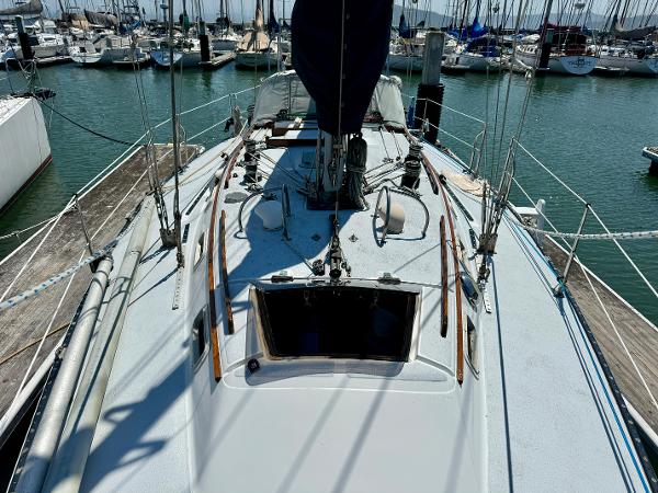 1979 Islander IP Peterson 40 sailboat docked at marina, view of deck and rigging.