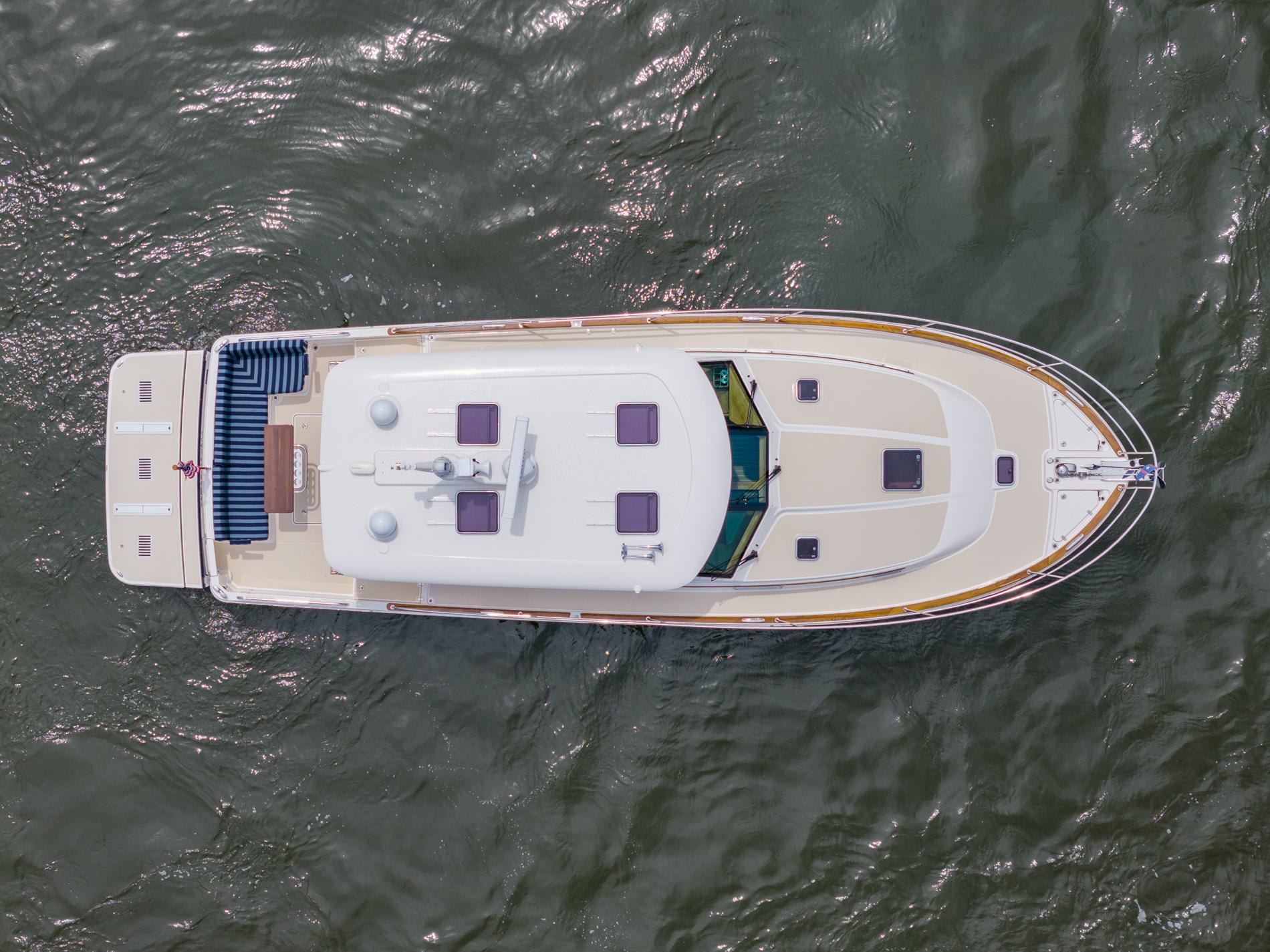 Aerial view of 2024 Sabre 43 Salon Express yacht cruising on water.