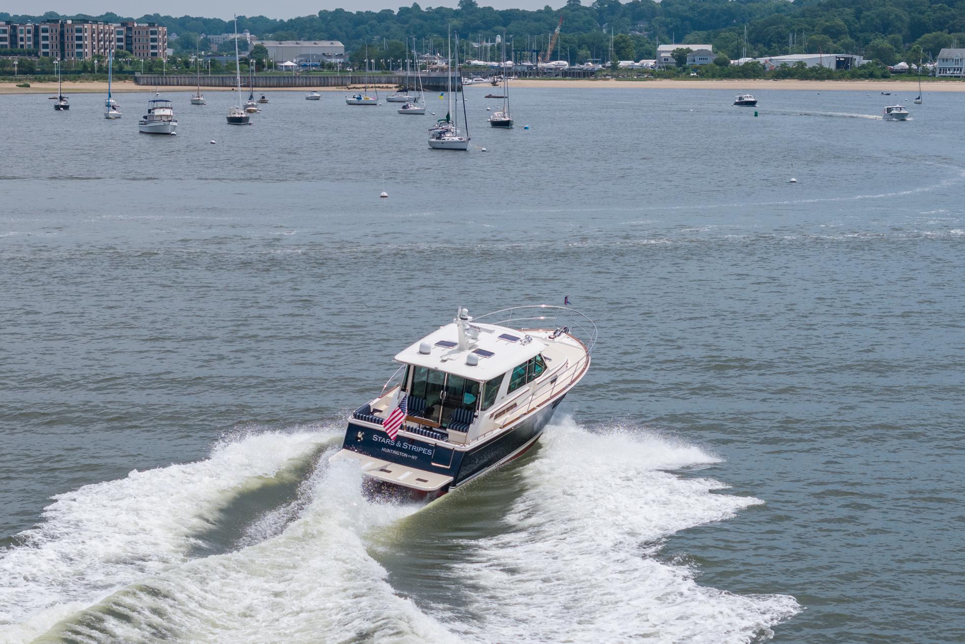 2024 Sabre 43 Salon Express cruising on a scenic waterway with other boats.