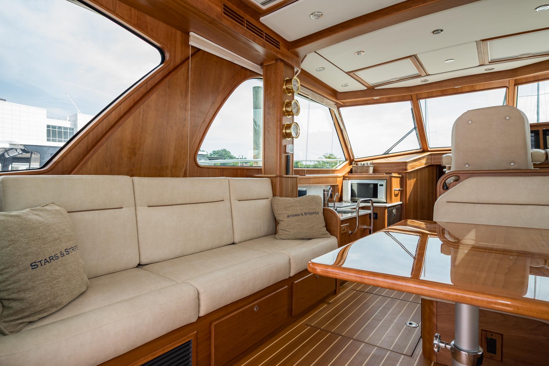 Luxurious interior of 2024 Sabre 43 Salon Express yacht with plush seating and elegant wood finishes.