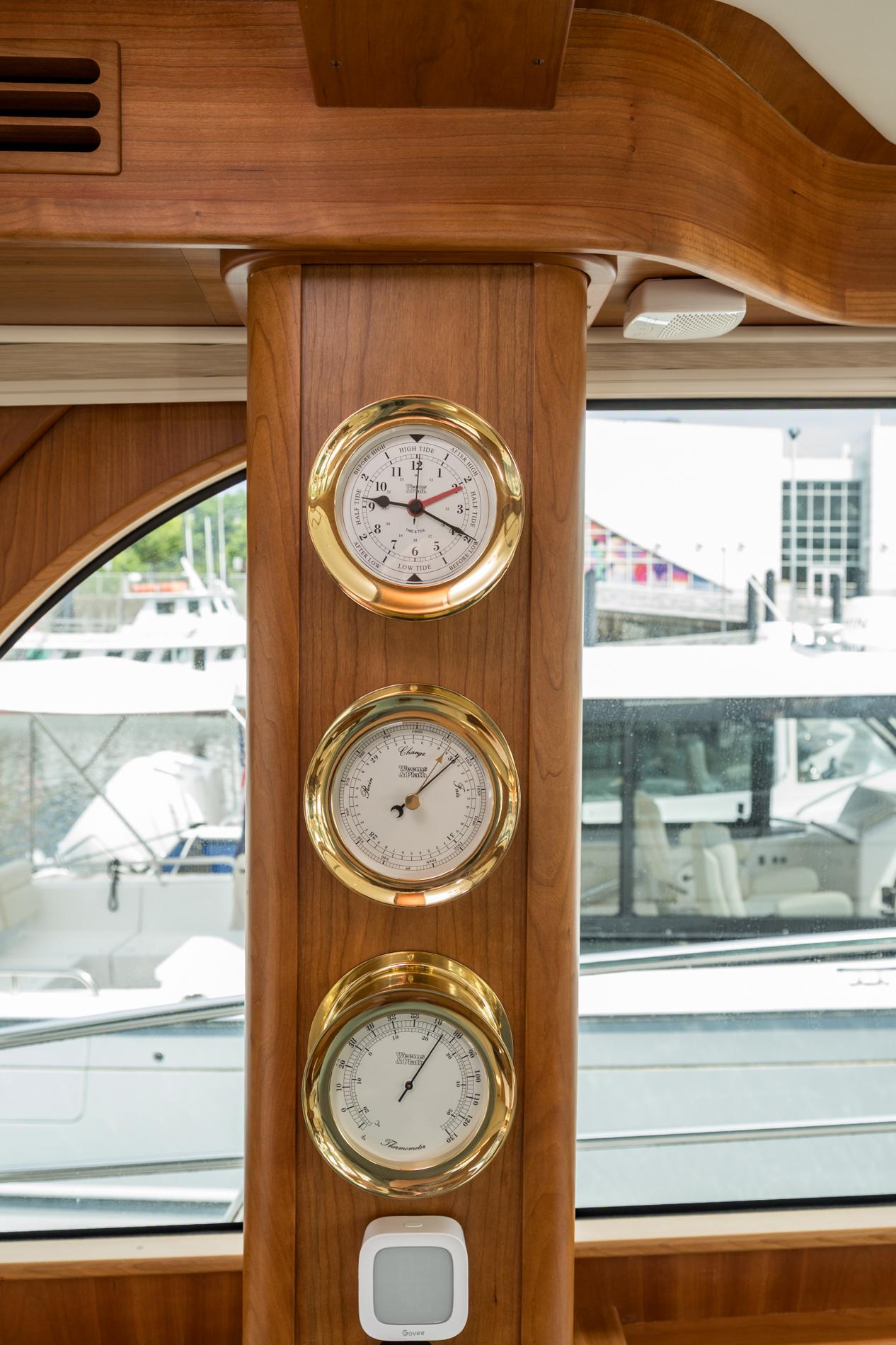 2024 Sabre 43 Salon Express interior with brass gauges and wooden paneling.