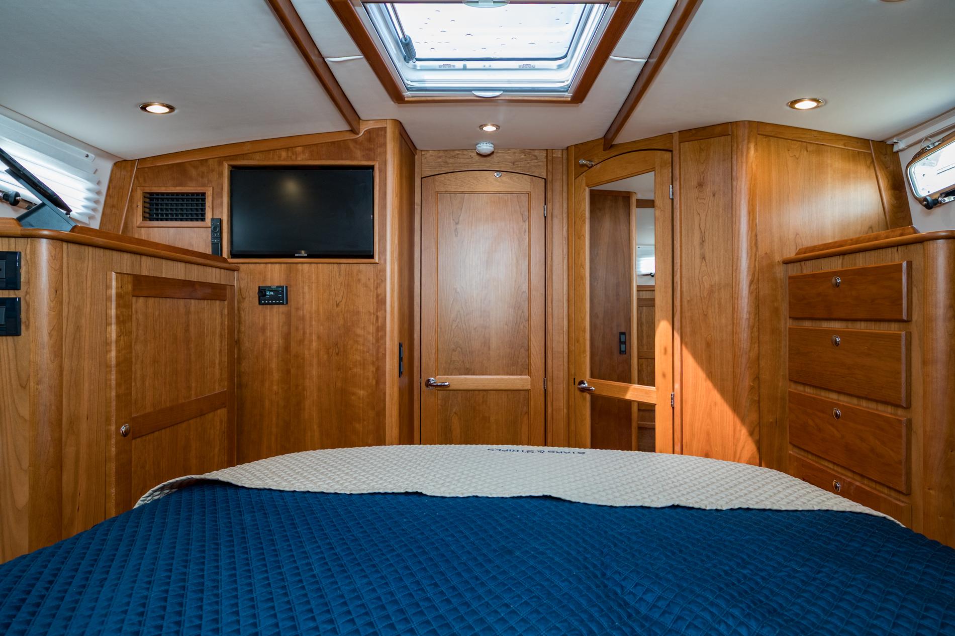 2024 Sabre 43 Salon Express cabin with wood interior, skylight, and TV.