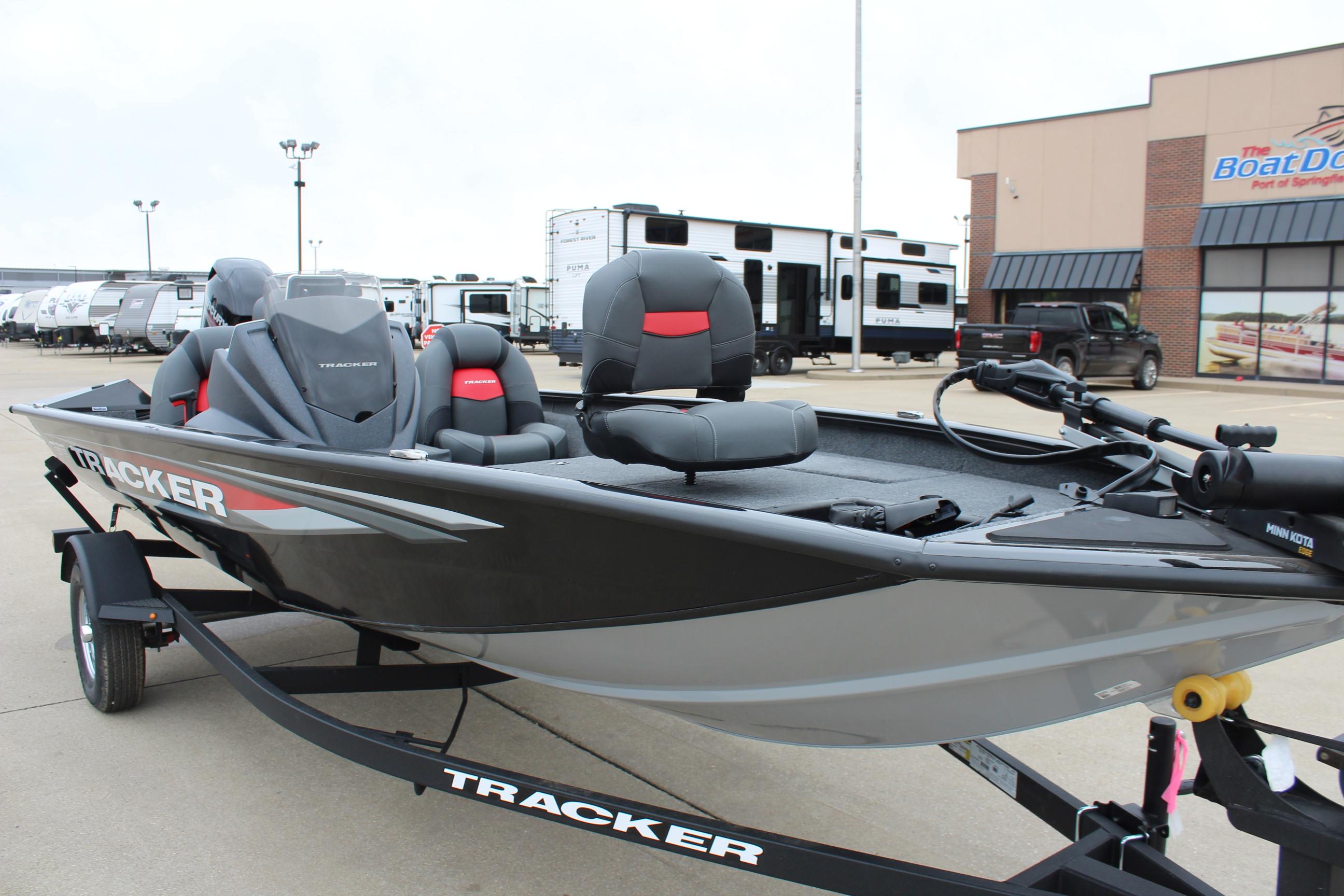 2025 Tracker Pro Team 175 Crappie Edition boat on trailer, parked outside dealership.