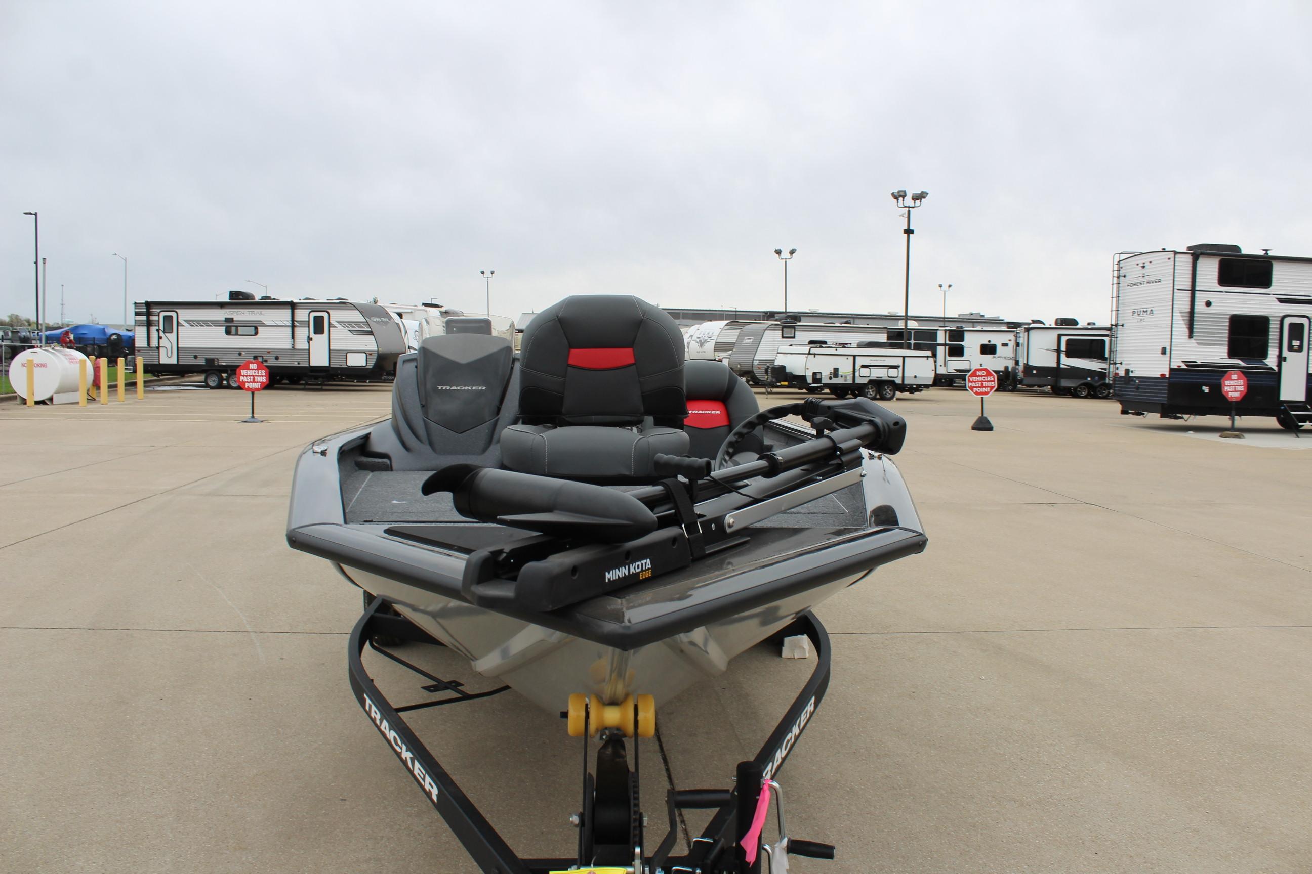 2025 Tracker Pro Team 175 Crappie Edition boat on trailer in parking lot.