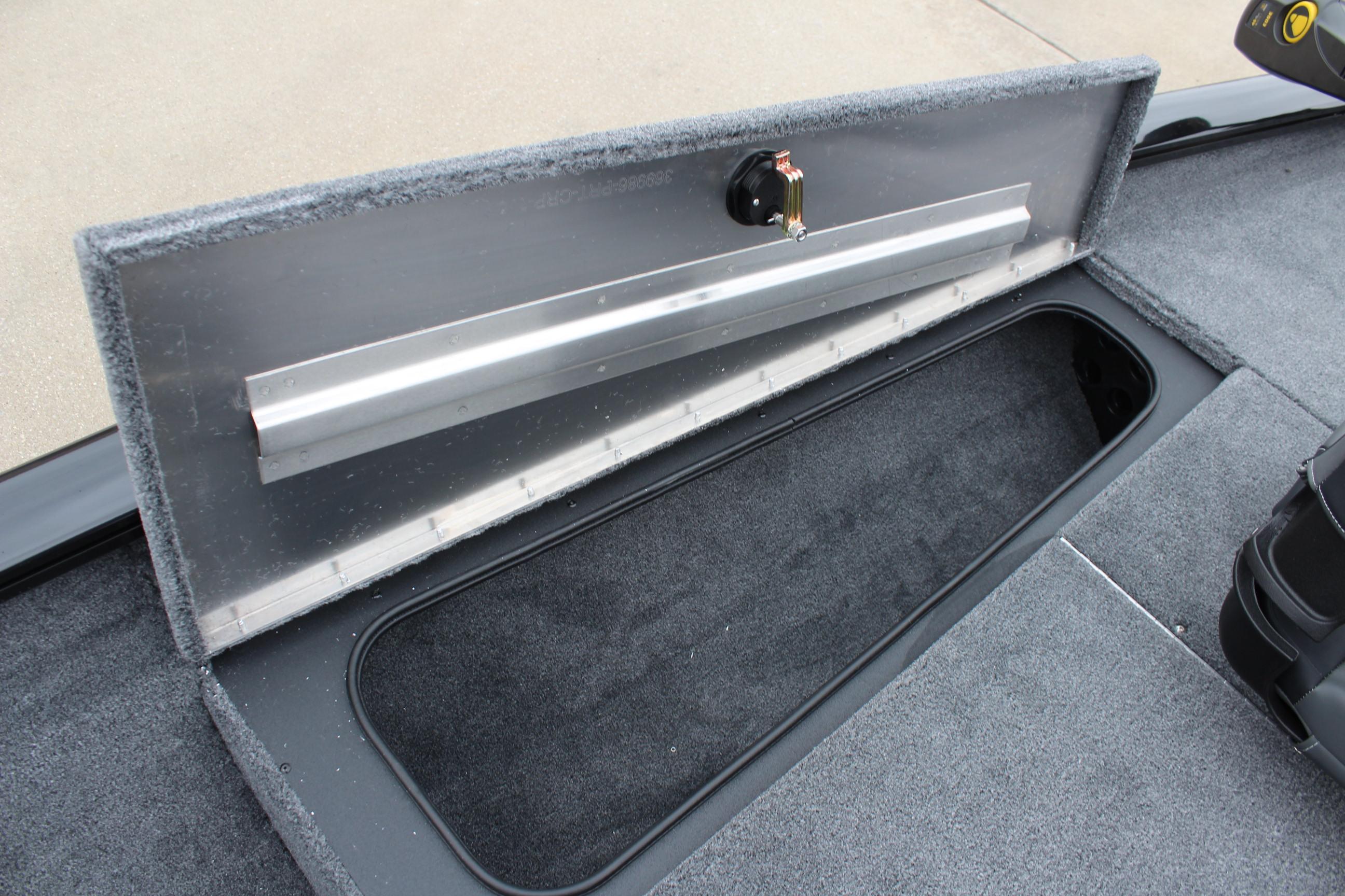 2025 Tracker Pro Team 175 Crappie Edition boat storage compartment, open and carpeted.