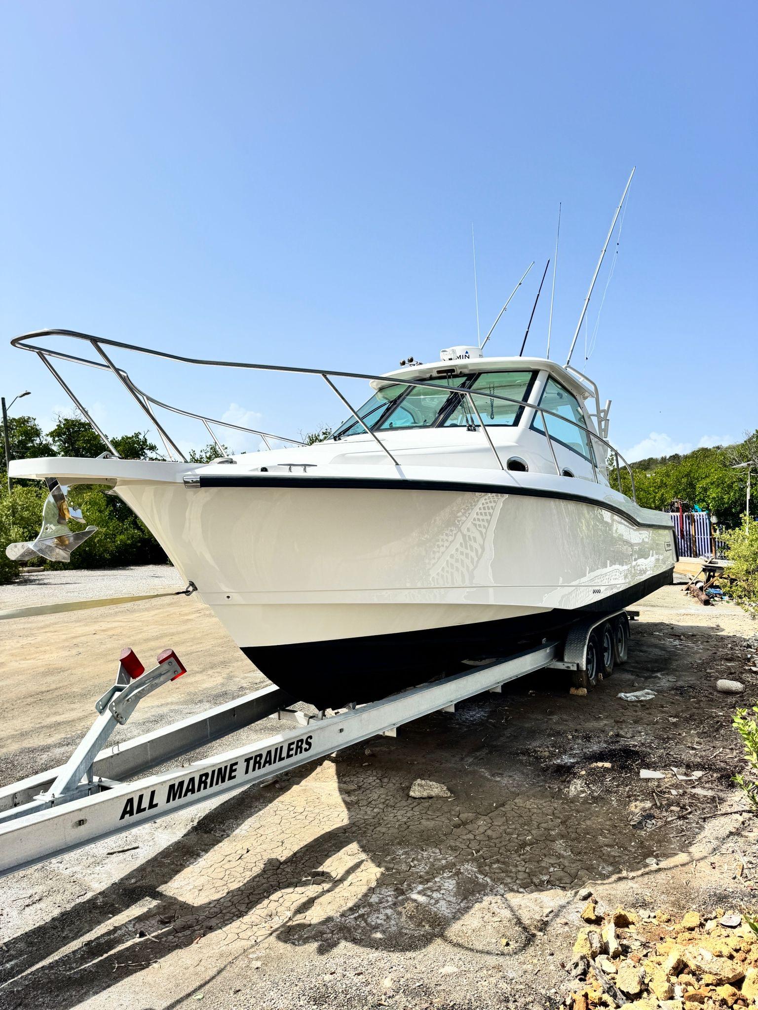 Boston Whaler-345 Conquest 2012 -PR-2012 Boston Whaler 345 Conquest boat on a trailer in a sunny outdoor setting.-9446483 | Thumbnail