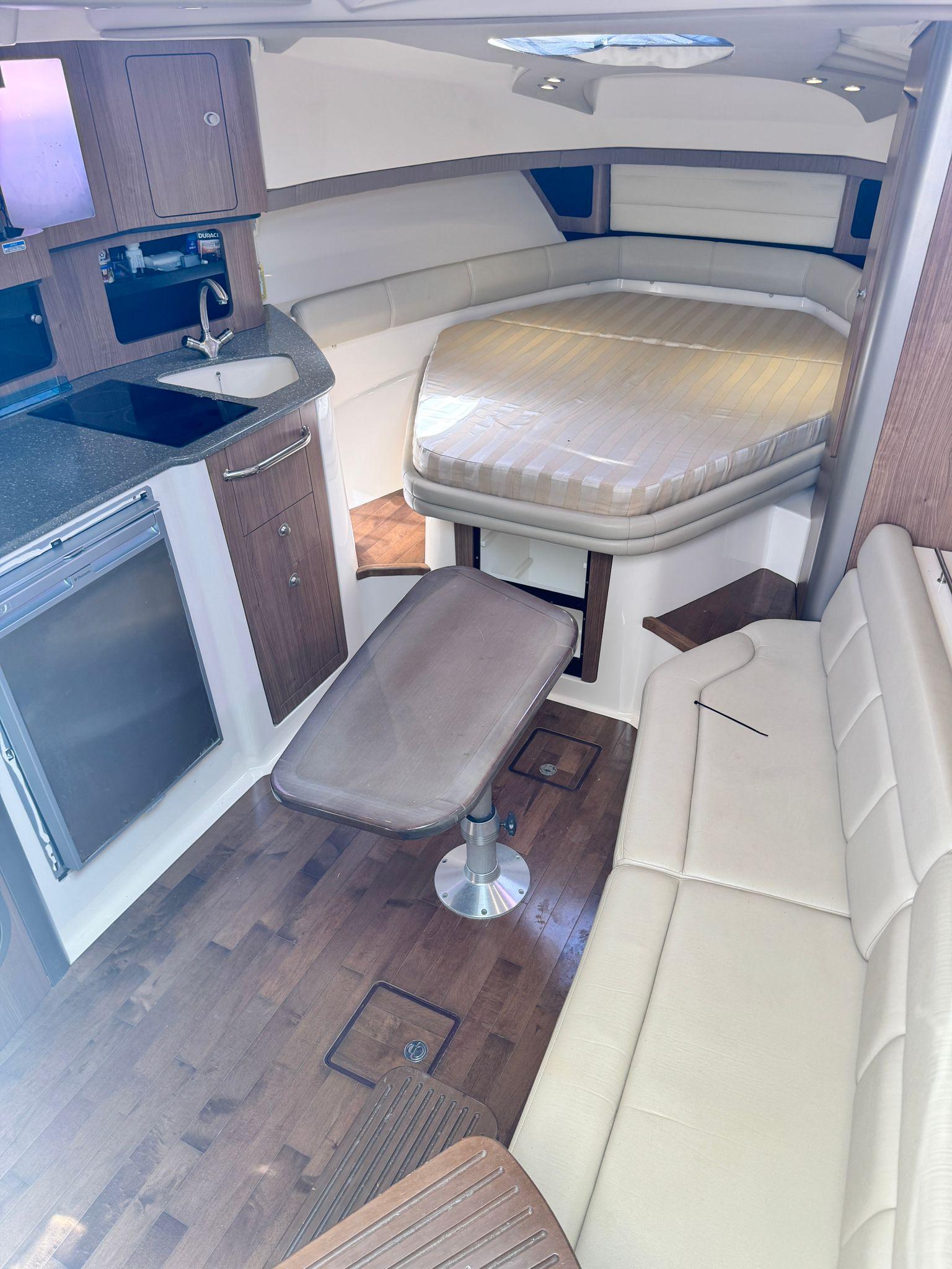 Boston Whaler-345 Conquest 2012 -PR-Interior of 2012 Boston Whaler 345 Conquest with kitchenette, seating, and bed.-9446483 | Thumbnail