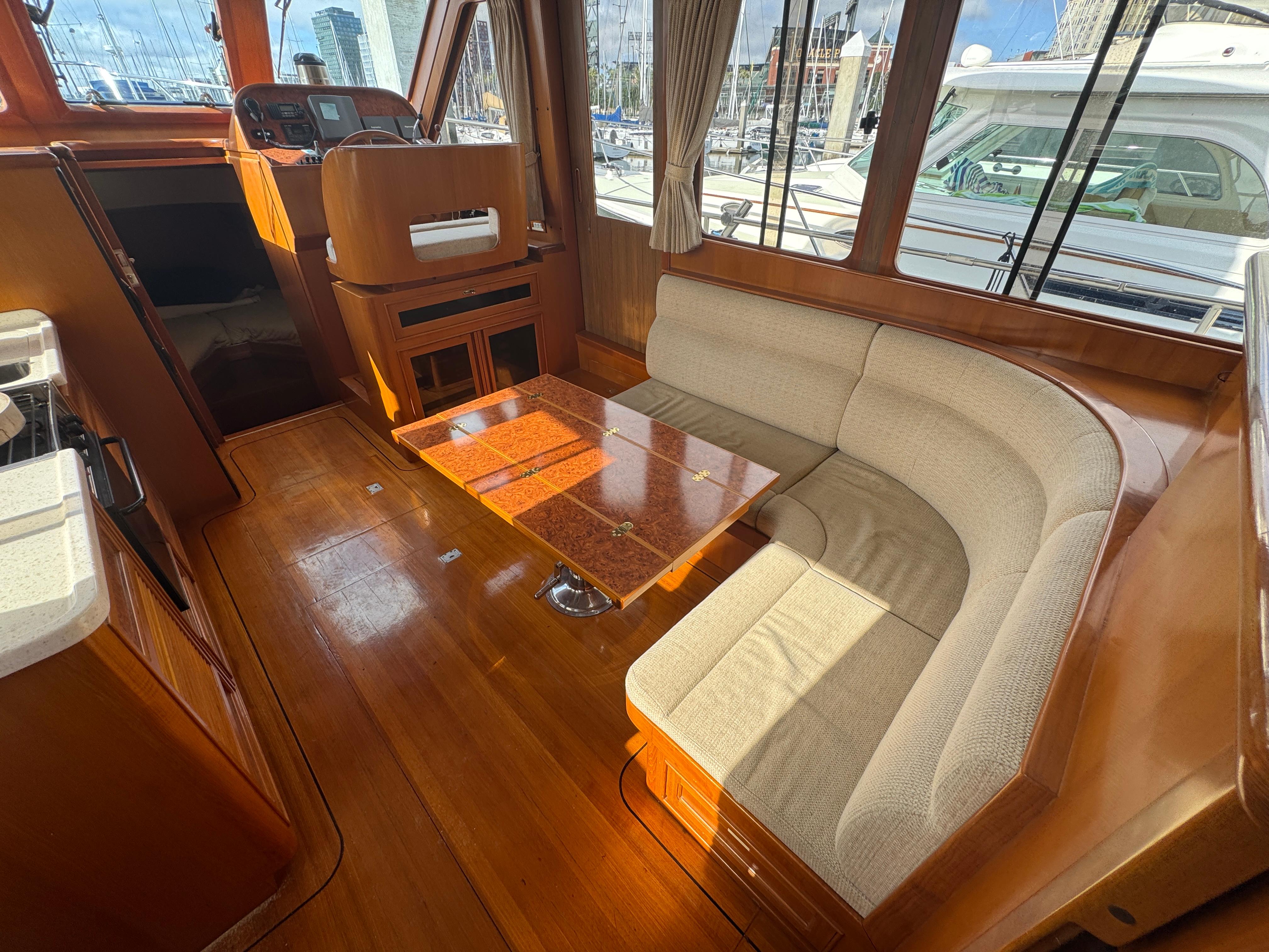 2003 President Performance Trawler interior with wood finish and cushioned seating area.