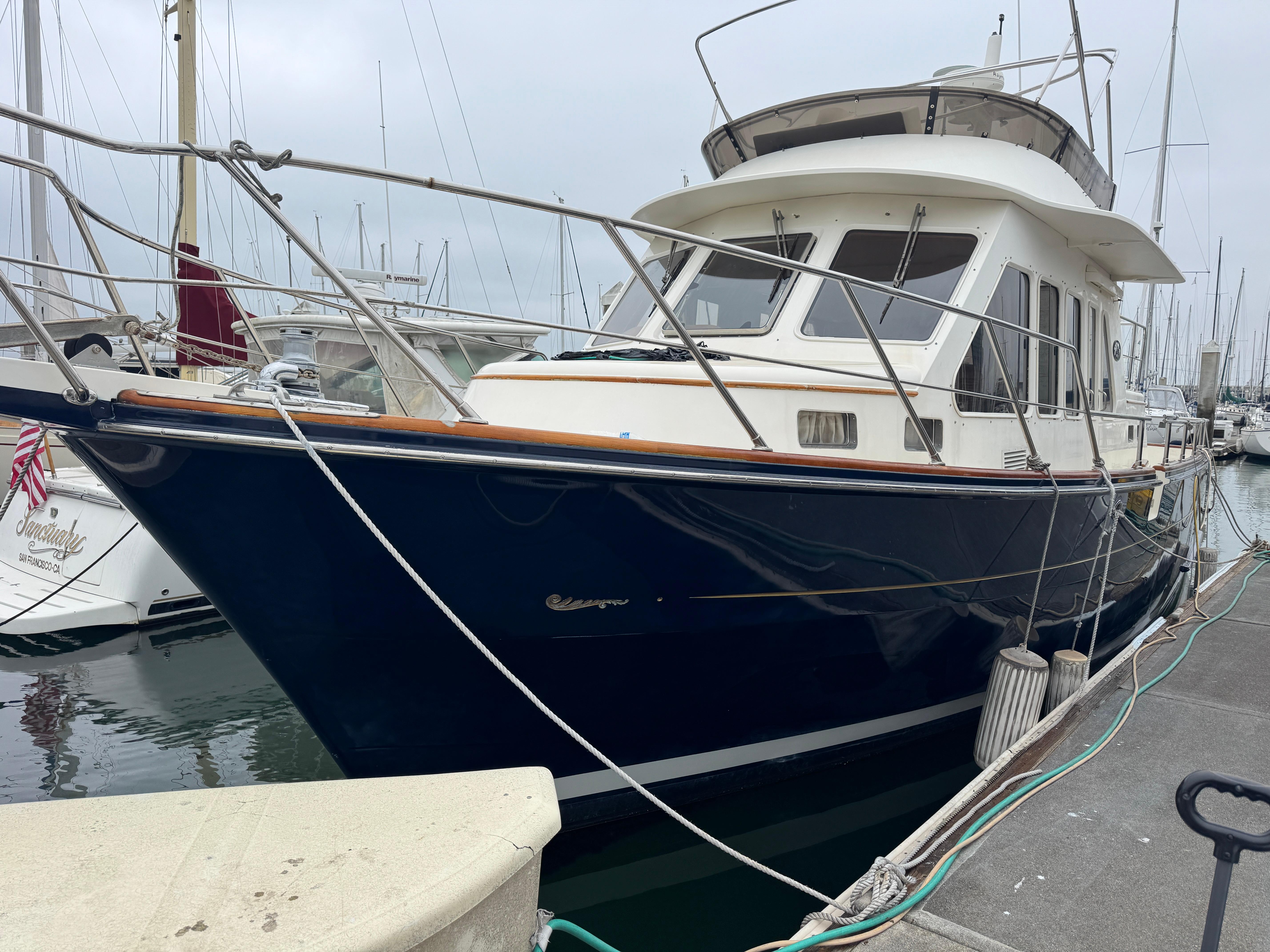 2003 President Performance Trawler docked at marina, showcasing sleek design and sturdy build.