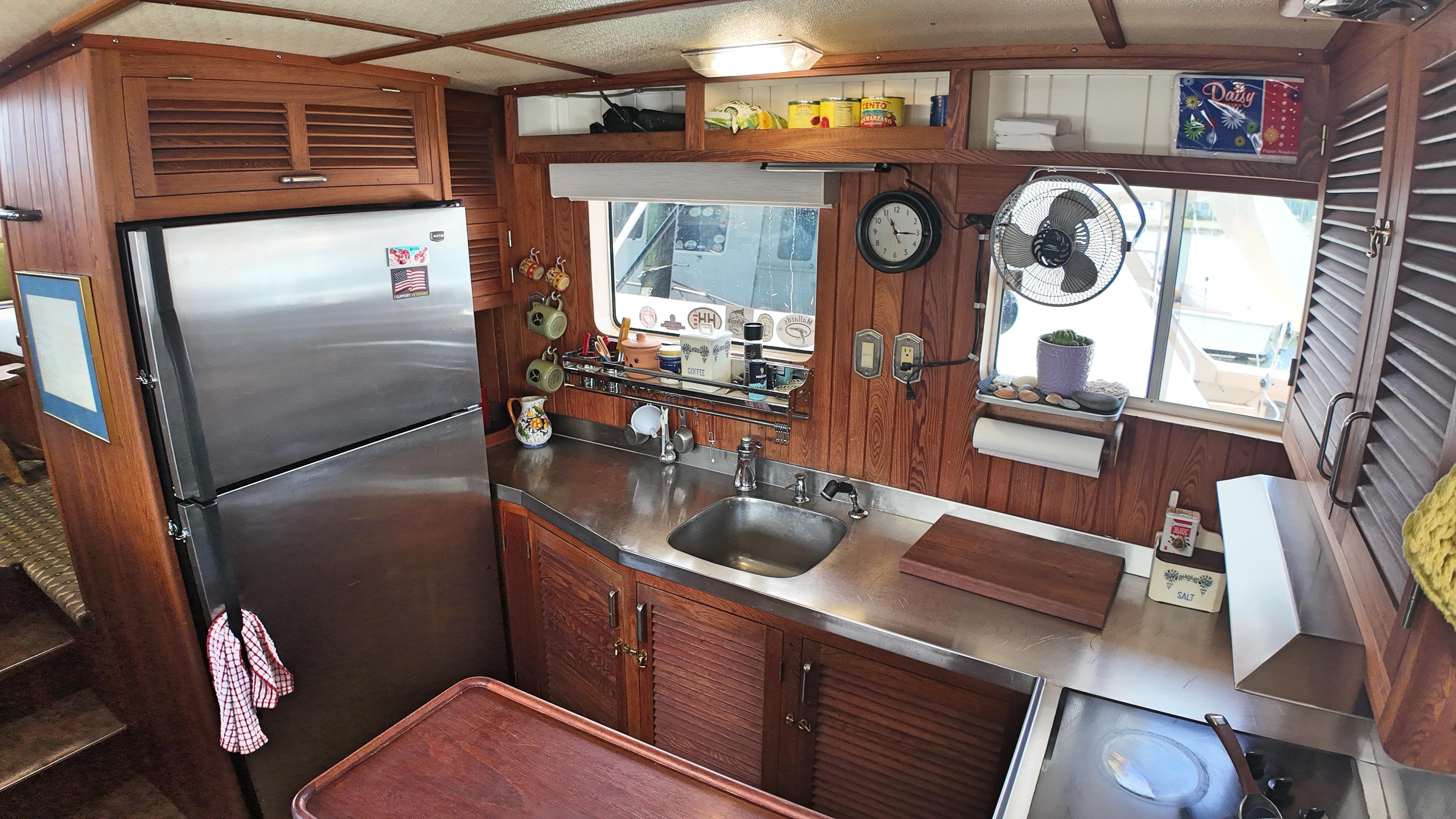 Custom-Holland Marine 50 Custom Trawler 1993-La Vita Marina SC-US-1993 Holland Marine 50 Custom Trawler kitchen with wood paneling and stainless steel appliances.-9816492 | Thumbnail