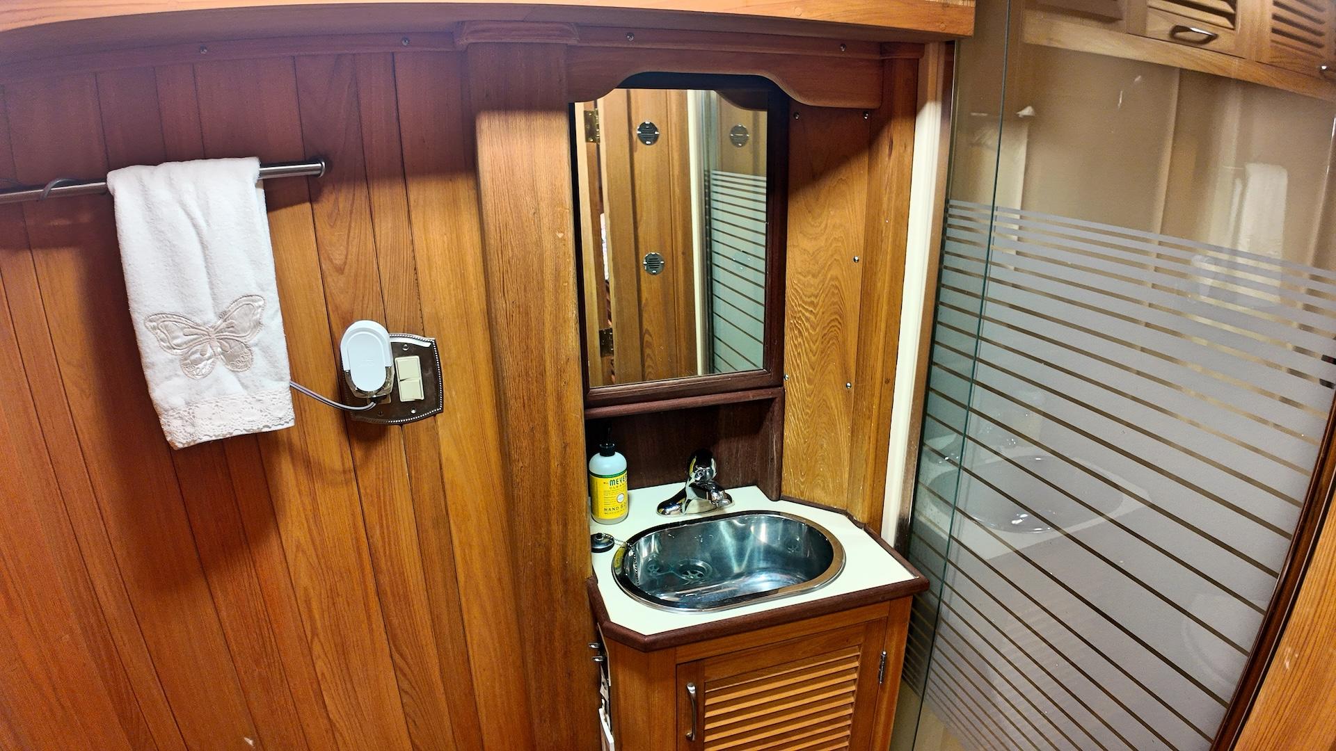 Custom-Holland Marine 50 Custom Trawler 1993-La Vita Marina SC-US-Bathroom interior of 1993 Holland Marine 50 Custom Trawler with wood paneling and stainless steel sink.-9816492 | Thumbnail