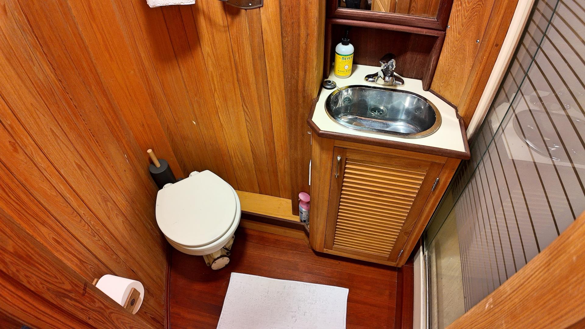 Custom-Holland Marine 50 Custom Trawler 1993-La Vita Marina SC-US-Wood-paneled bathroom in 1993 Holland Marine 50 Custom Trawler with sink and toilet.-9816492 | Thumbnail