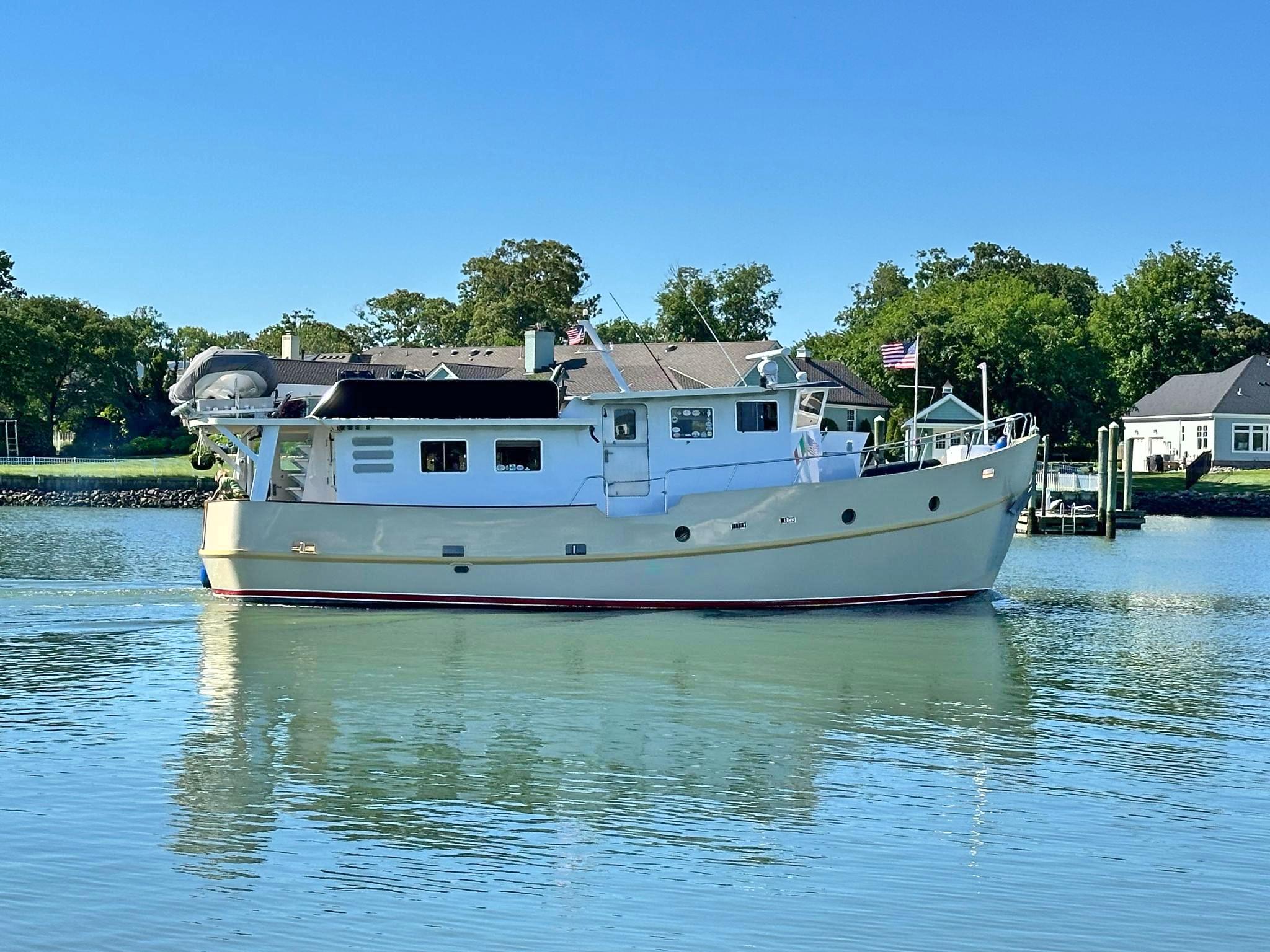 Custom-Holland Marine 50 Custom Trawler 1993-La Vita Marina SC-US-Custom Holland Marine 50 Trawler, 1993, cruising on calm waters with trees and houses in the background.-9816492 | Thumbnail