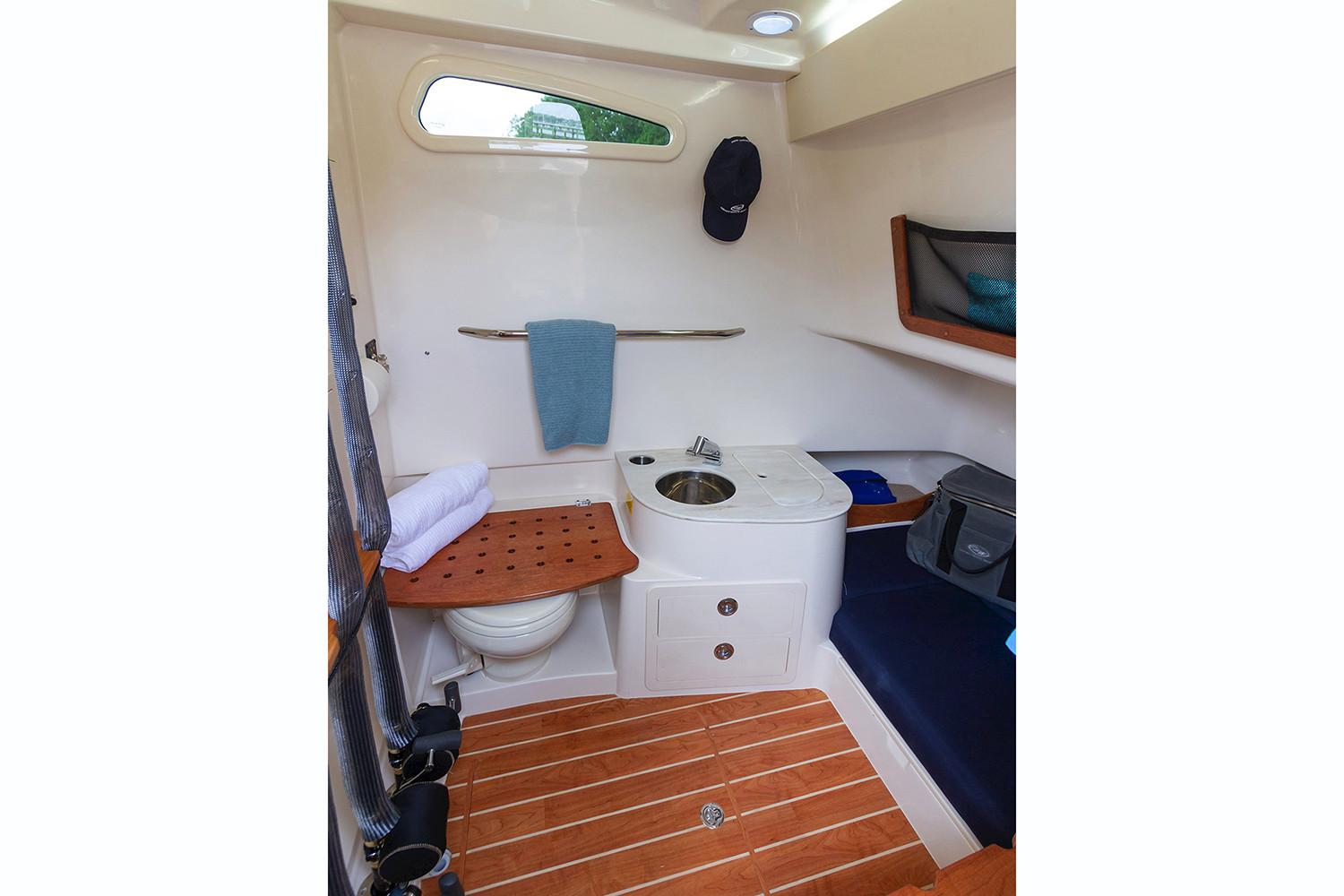 Manufacturer Provided Image: 2020 Grady-White Canyon 336 boat interior with wooden flooring and compact amenities.