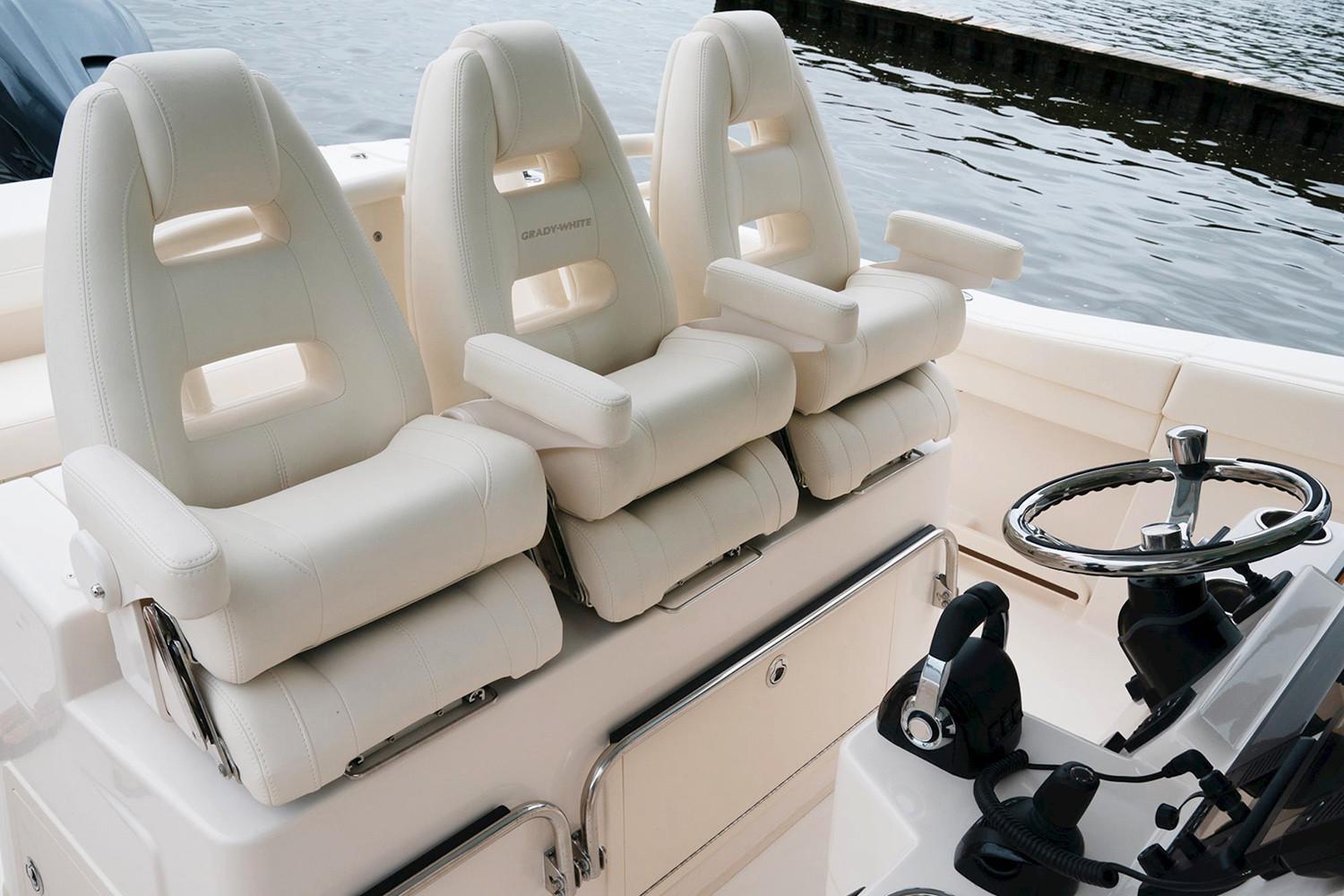 Manufacturer Provided Image: 2020 Grady-White Canyon 336 boat interior with three white captainu0027s chairs and steering wheel.