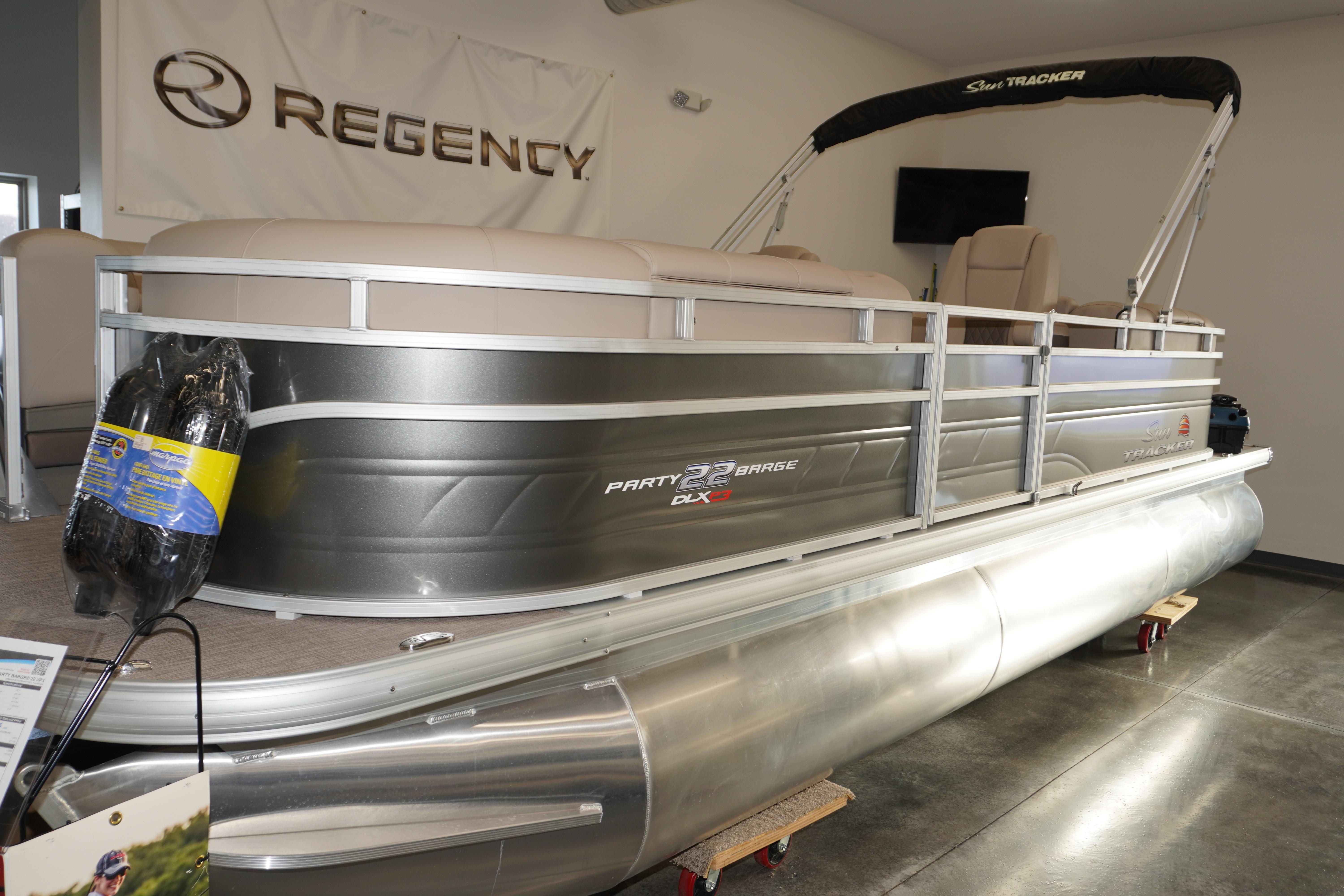 2024 Sun Tracker Party Barge 22 XP3 pontoon boat displayed indoors.