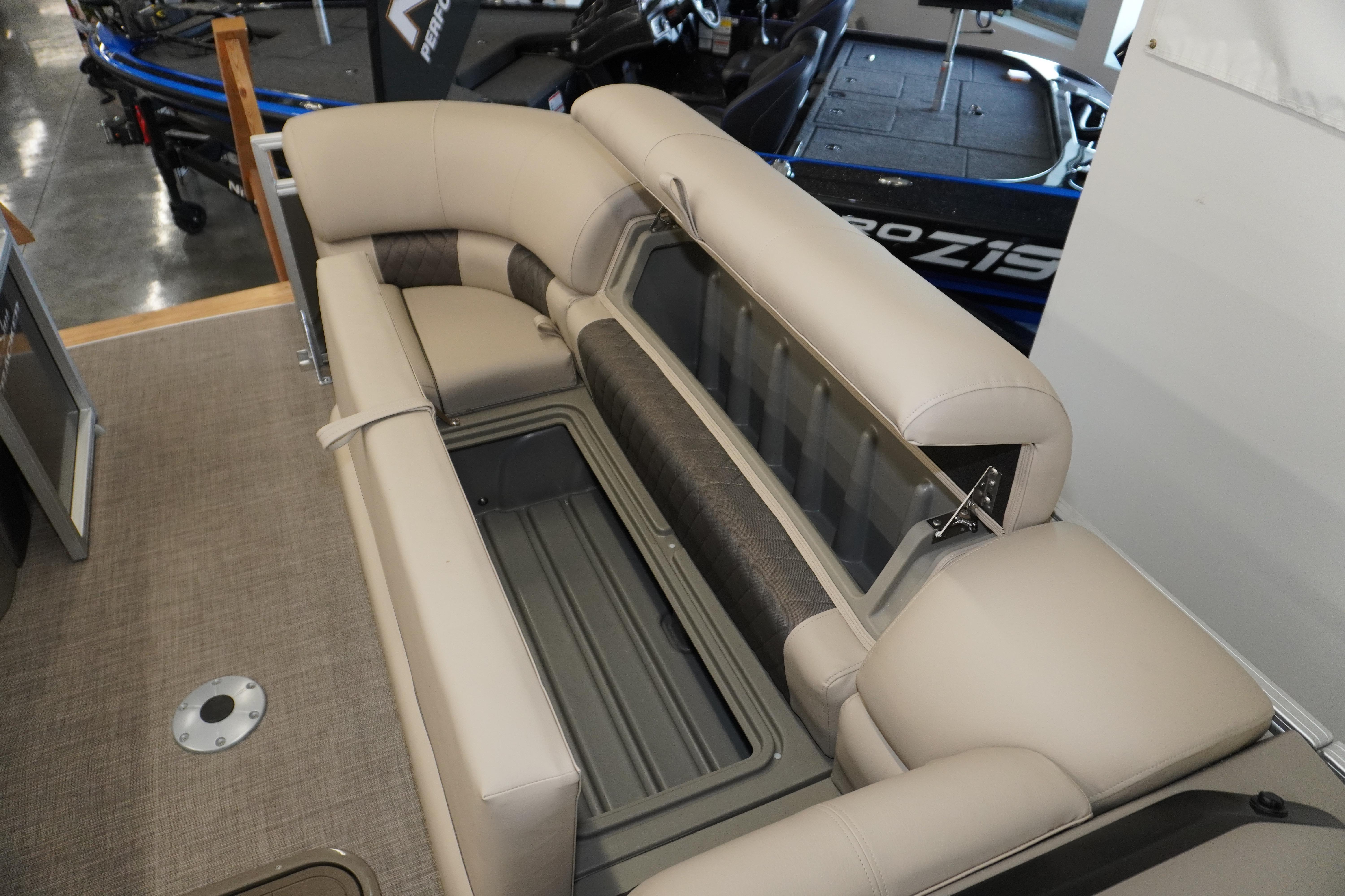 2024 Sun Tracker Party Barge 22 XP3 interior seating with storage compartment open.