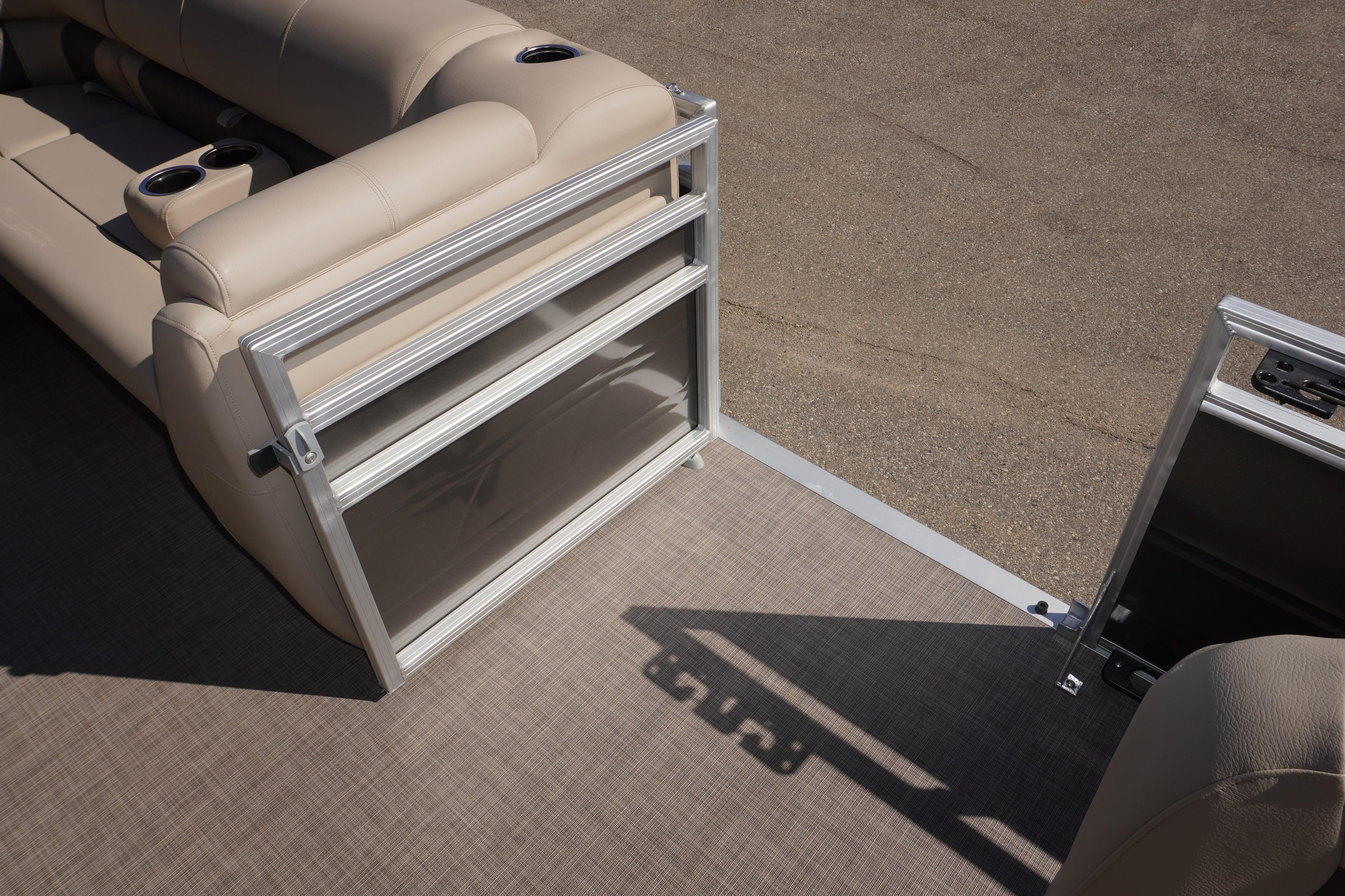 2024 Sun Tracker Fishin' Barge 20 DLX interior with beige seating and cup holders.