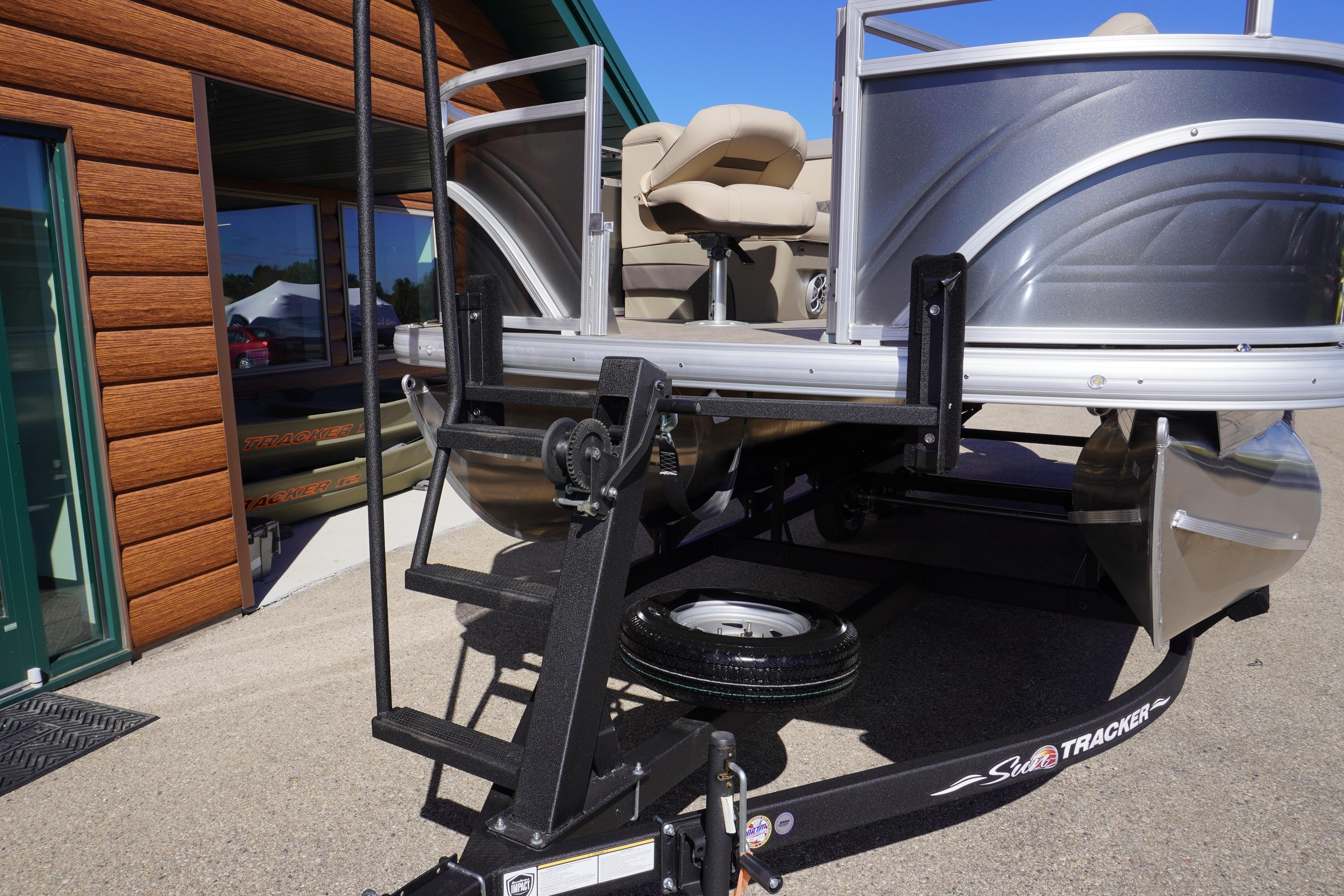 2024 Sun Tracker Fishin' Barge 20 DLX pontoon boat on trailer, outdoor display.