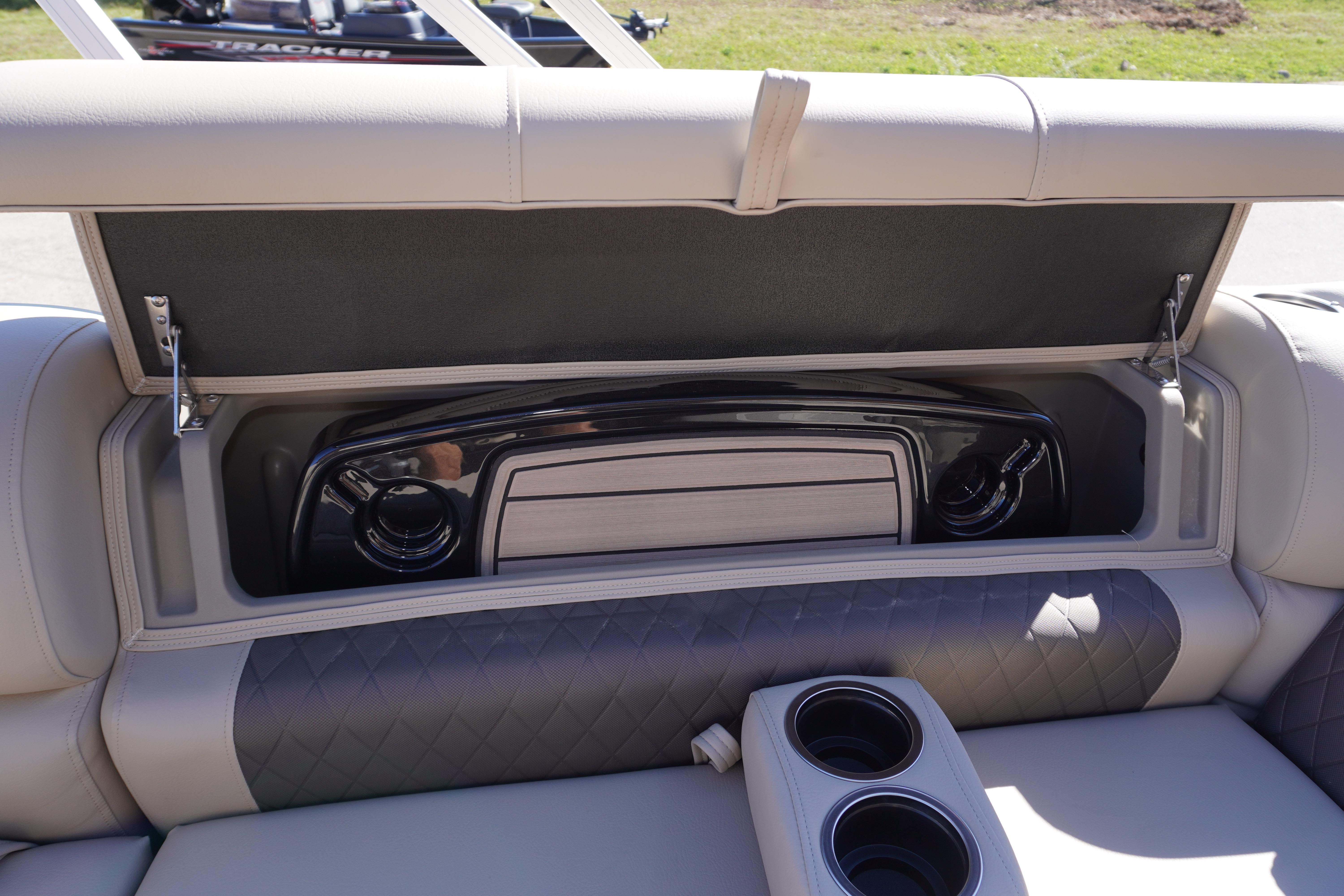 2024 Sun Tracker Fishin' Barge 20 DLX storage compartment with cup holders and sleek design.